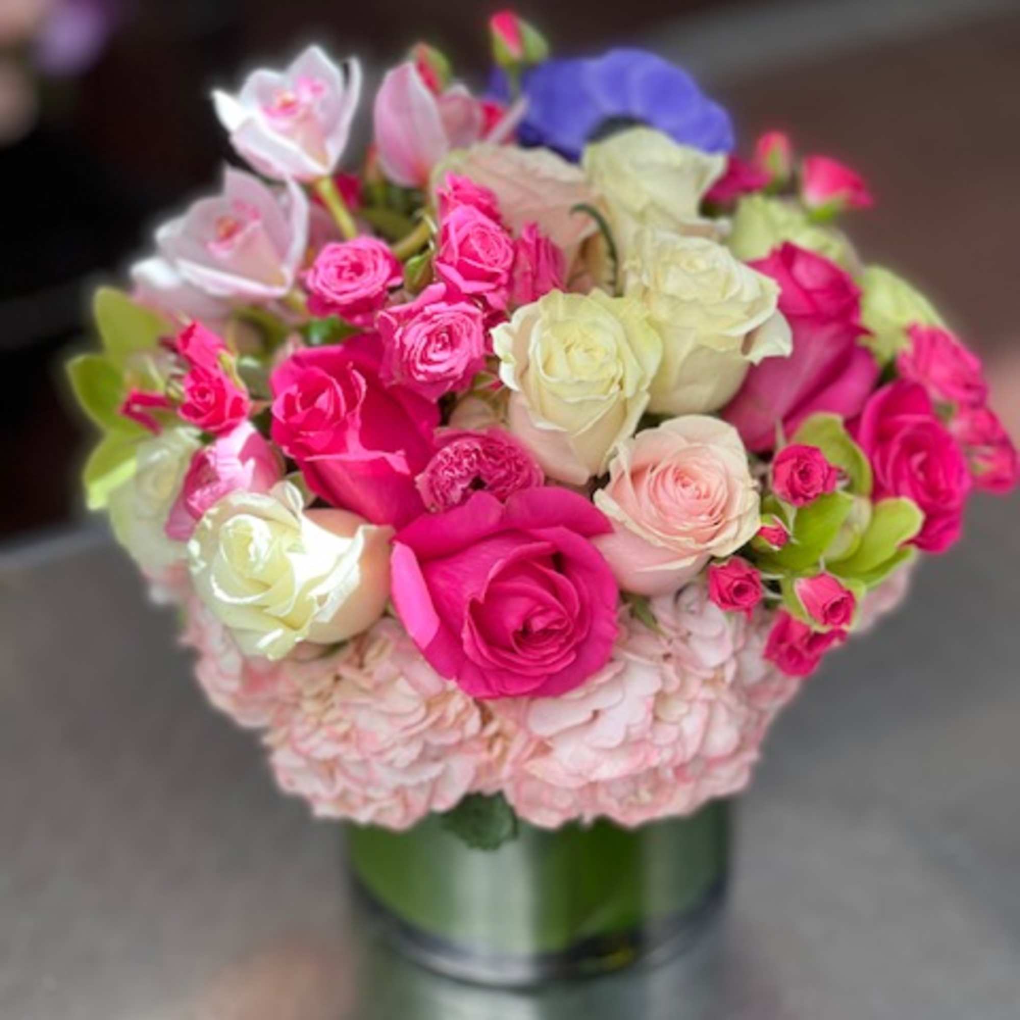 Pink and white rose bouquet in a glass vase