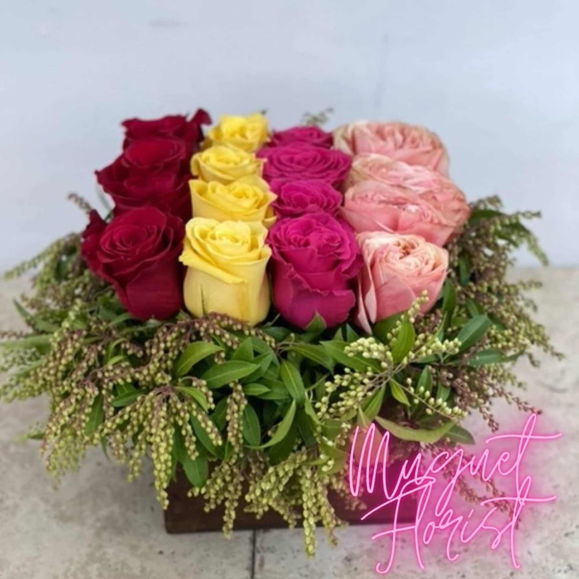 Box arrangement of multicolored roses with greenery