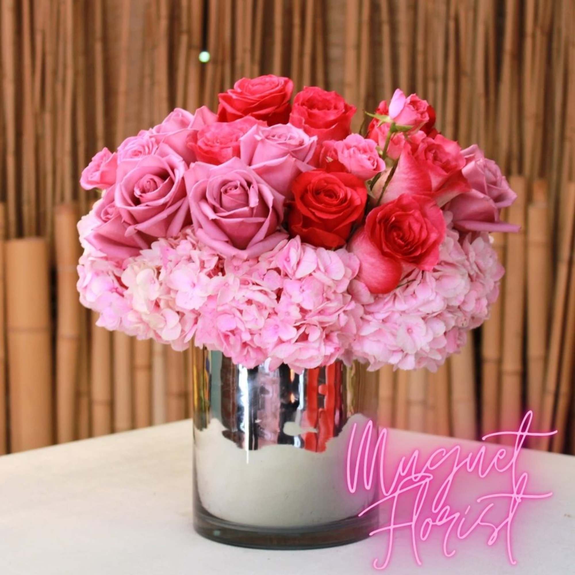Pink and red roses arranged in a mirrored vase, photo 3 of 3