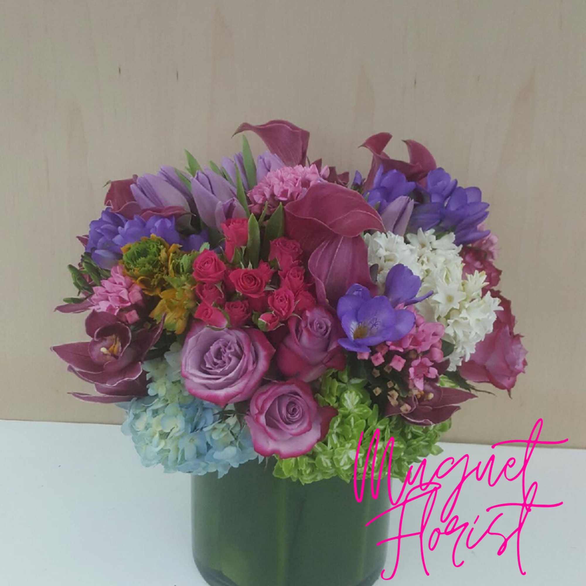 Mixed bouquet of purple, pink, and white flowers in a green vase, photo 3 of 4