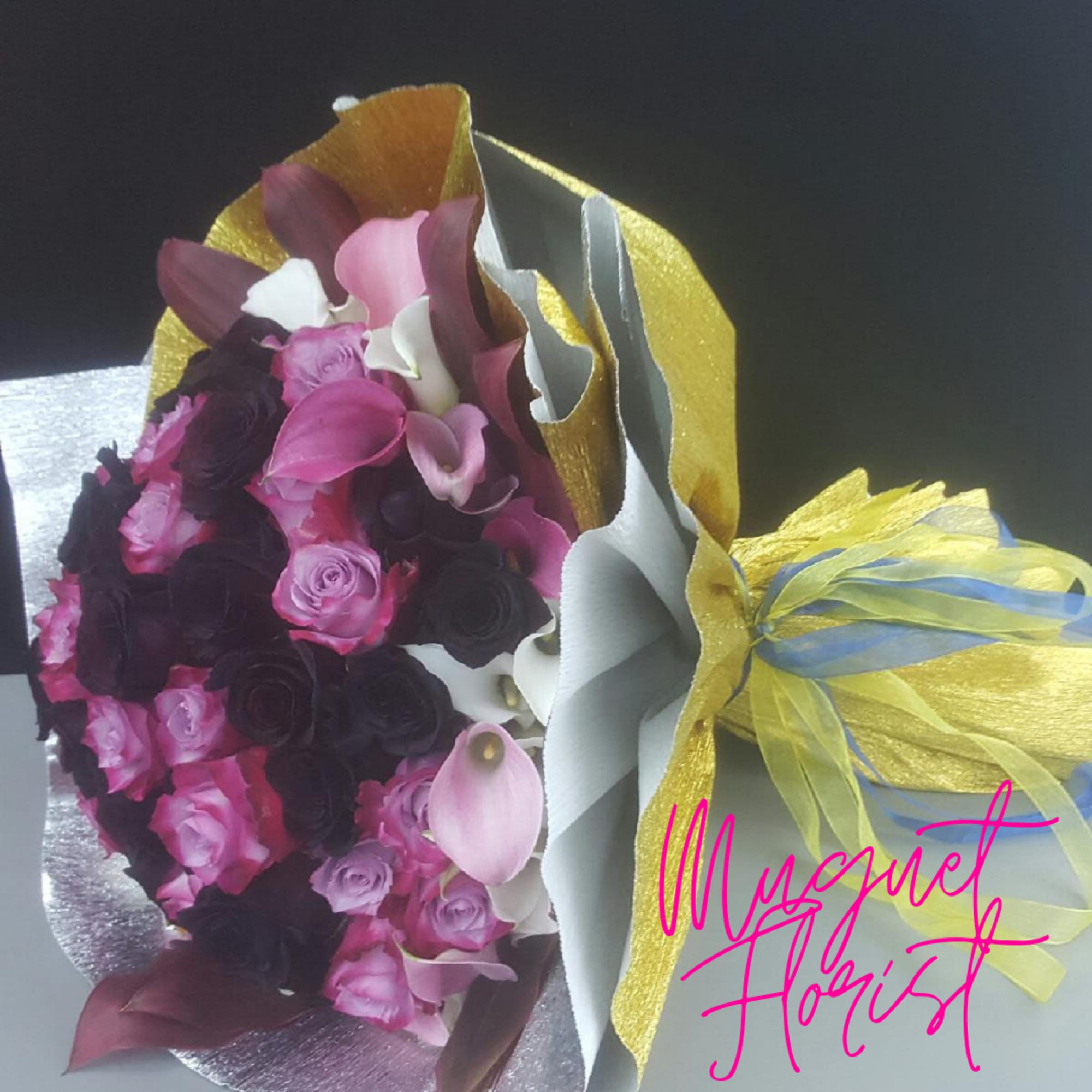 Bouquet of pink and dark purple roses with pink calla lilies