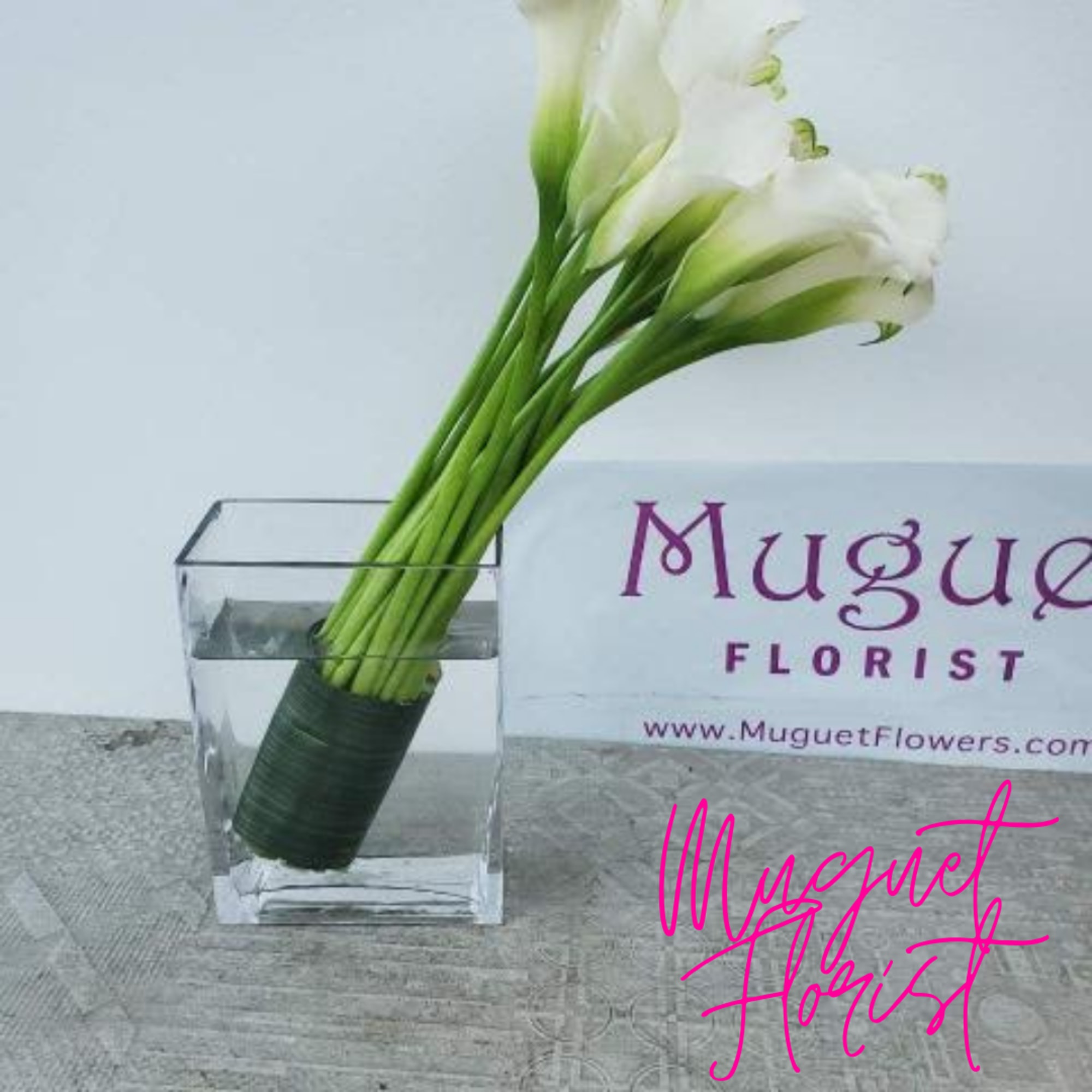 White calla lilies in a clear square vase, photo 2 of 4