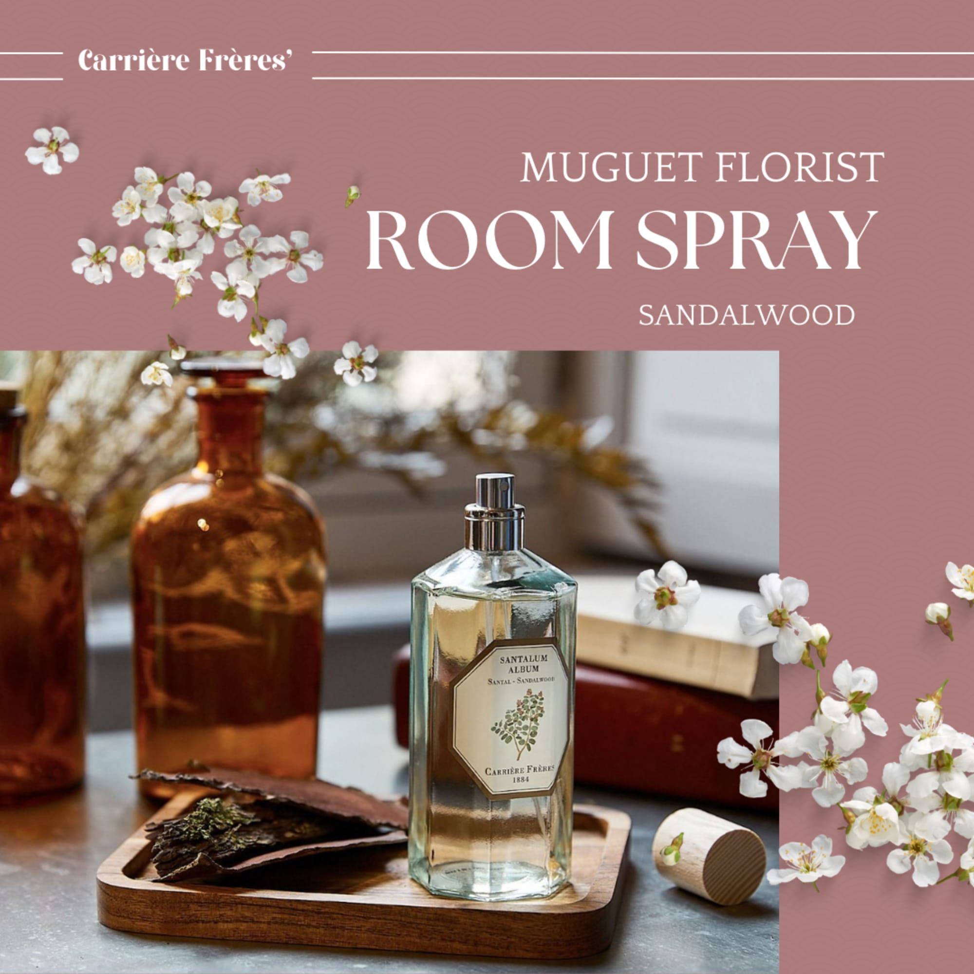 Room spray bottle with white blossoms and amber glass bottles