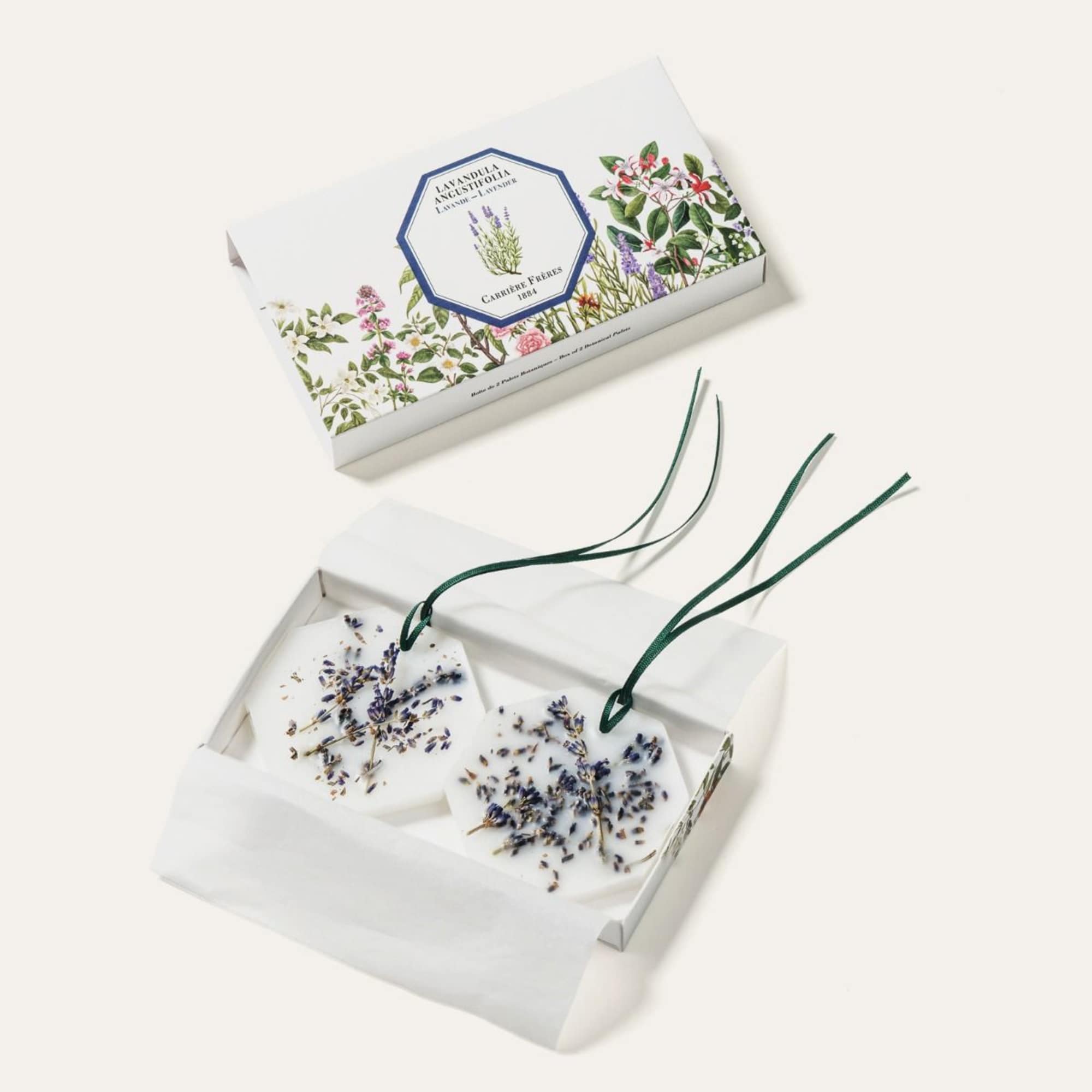 Two floral wax sachets in a gift box with lavender sprigs