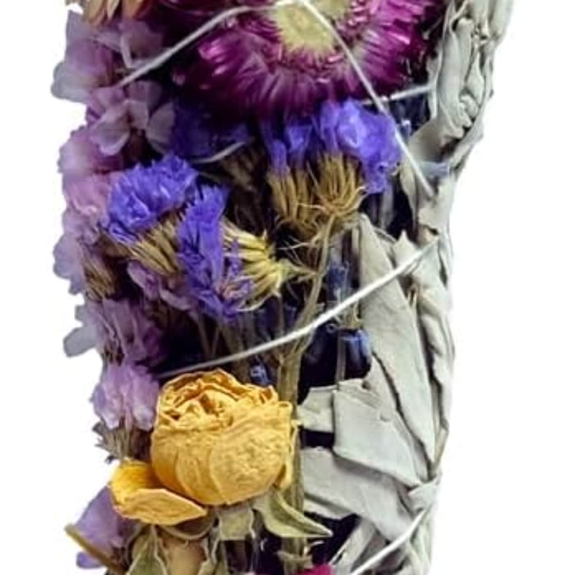 Bundle of dried flowers wrapped with pale leaves and tied with string