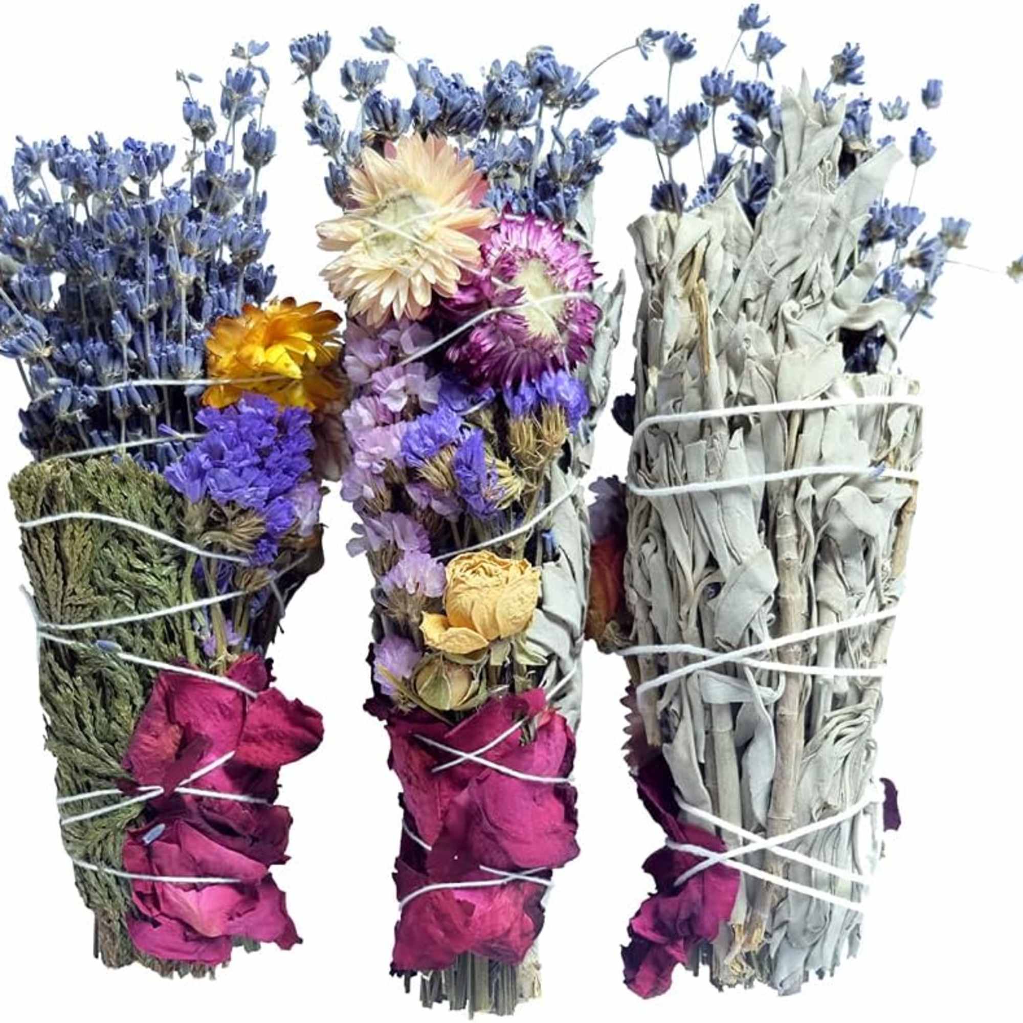 Bundles of dried flowers and sage tied with string