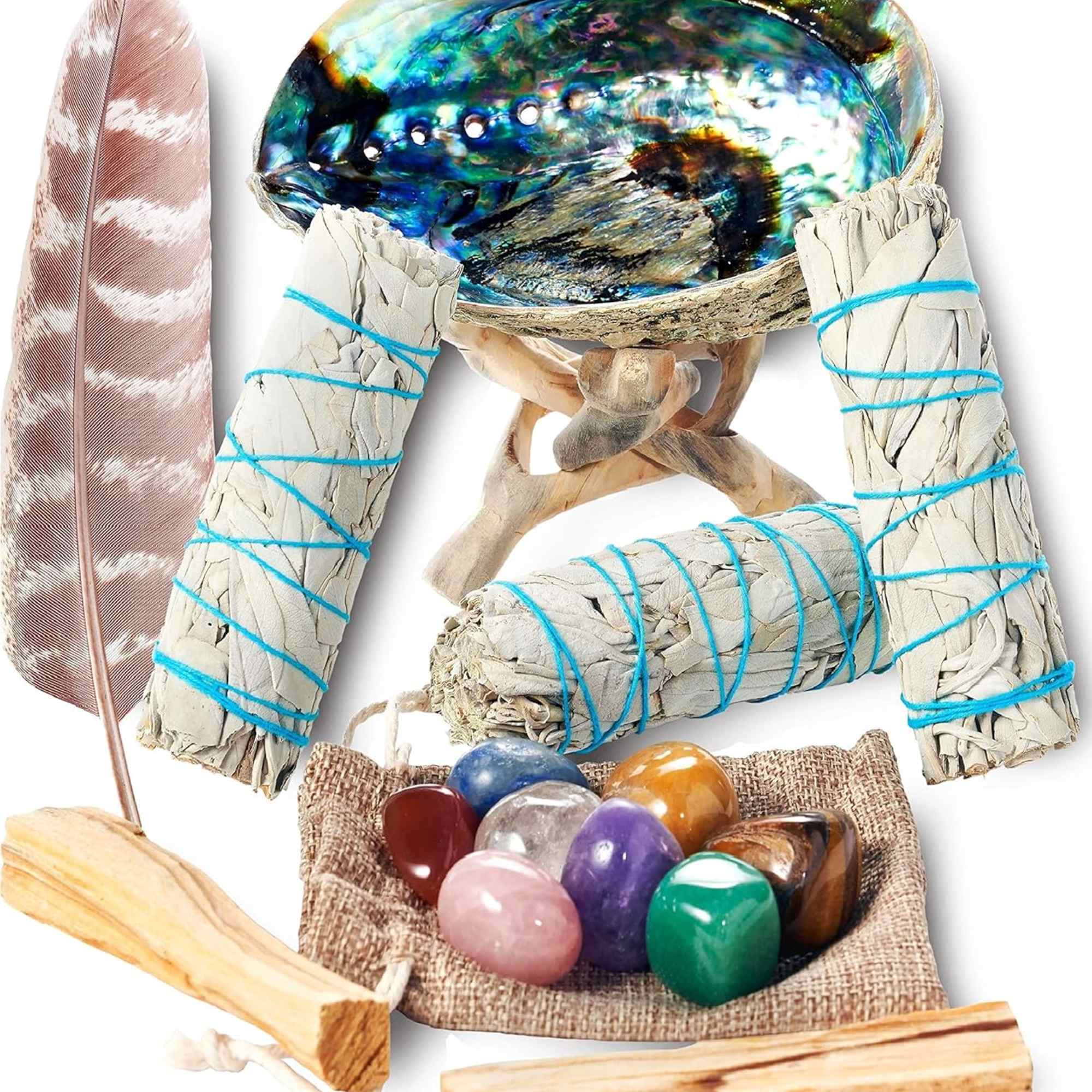 Smudge sticks, an abalone shell, a feather, and polished stones