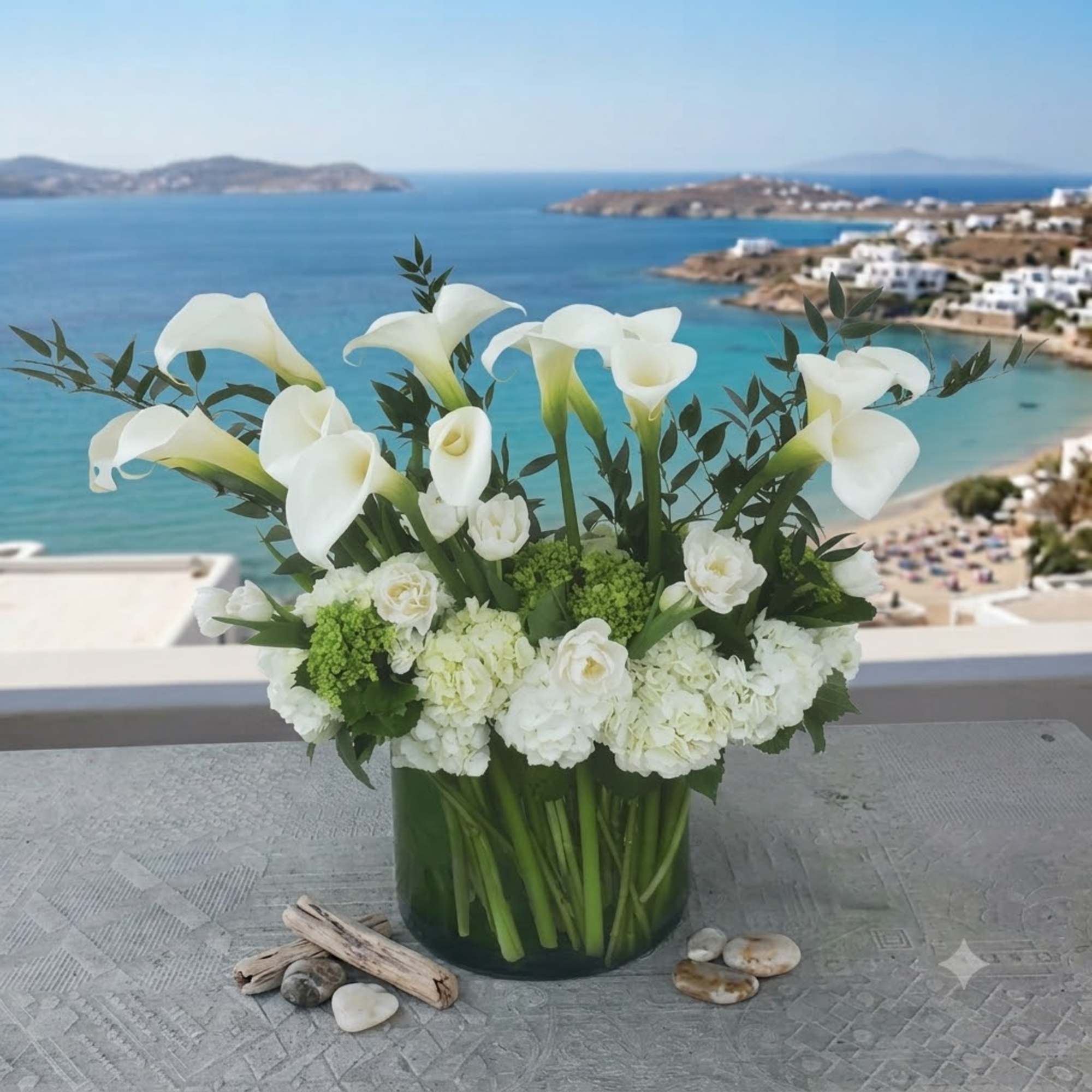 White calla lilies and hydrangeas in a glass vase
