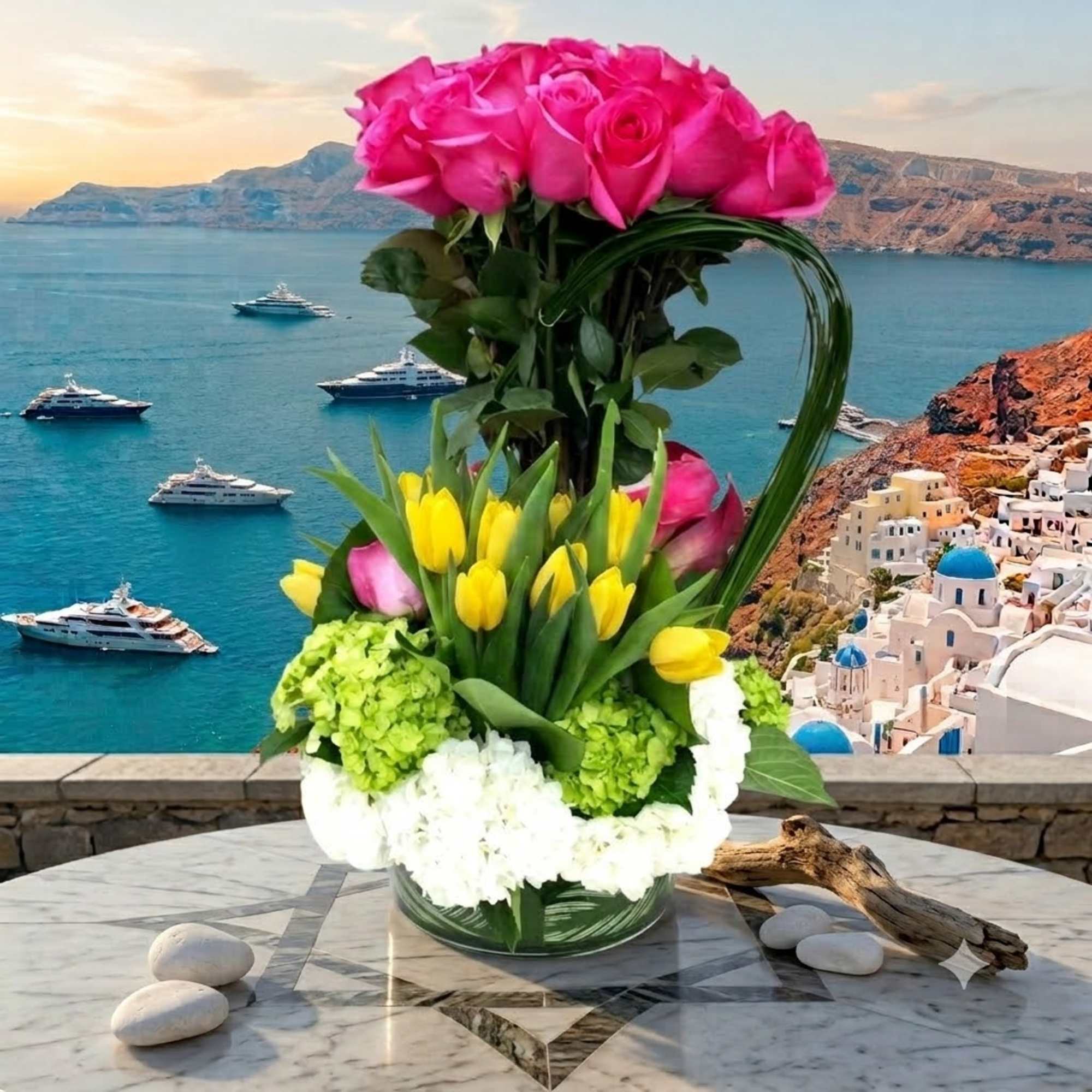Tall floral arrangement with pink roses, yellow tulips, and white hydrangeas in a glass vase