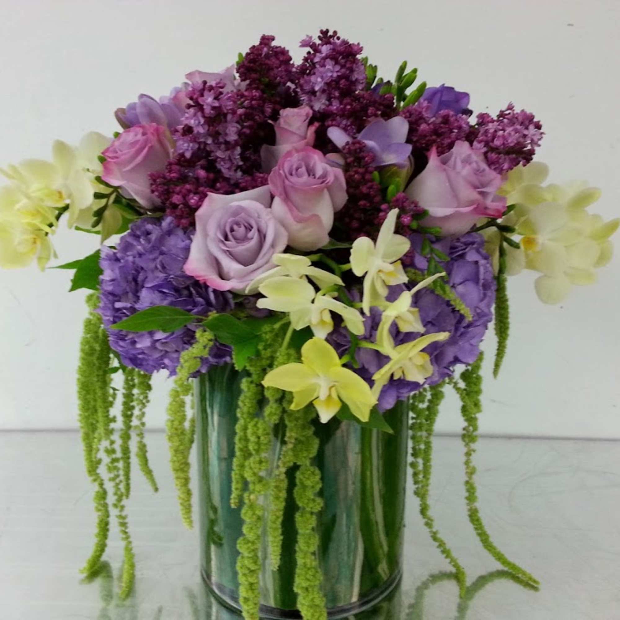 Purple and pink flower arrangement in a glass vase