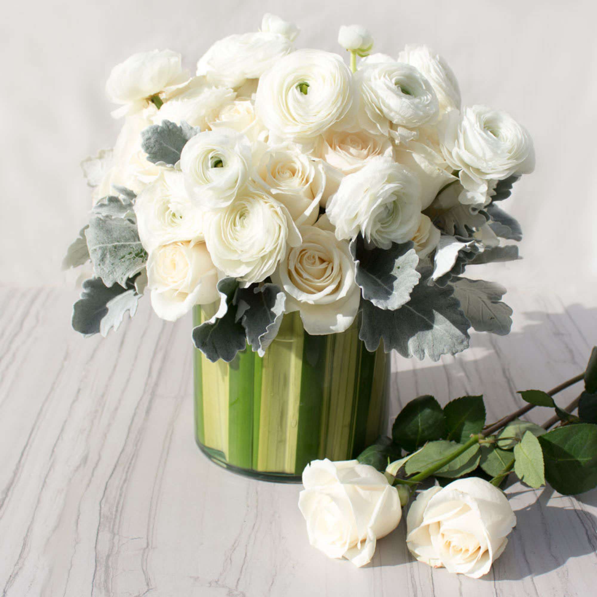 Full of life and natural beauty, this arrangement features a leaved glass