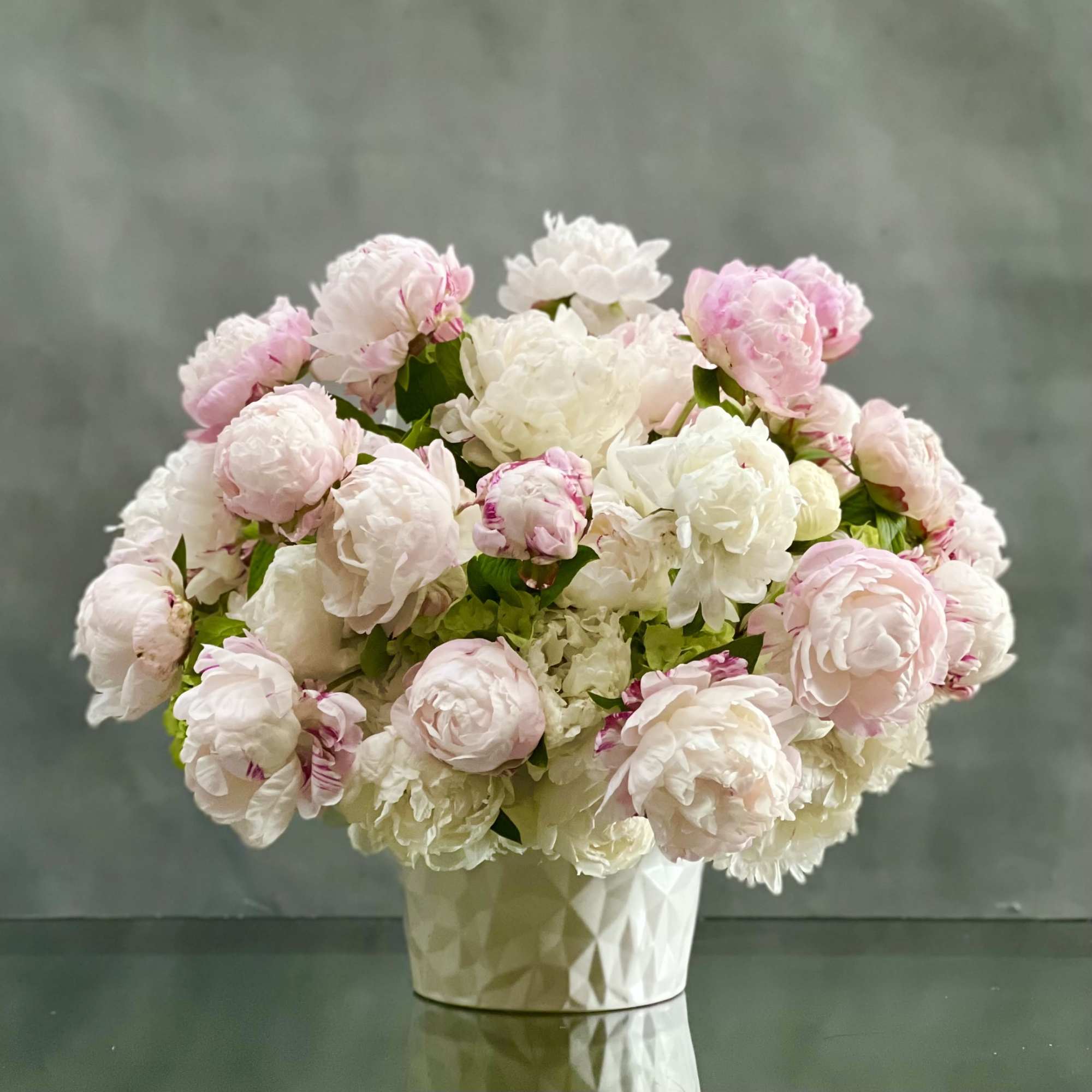 Graceful and stunning over 70 blooms of blush and white peonies nested