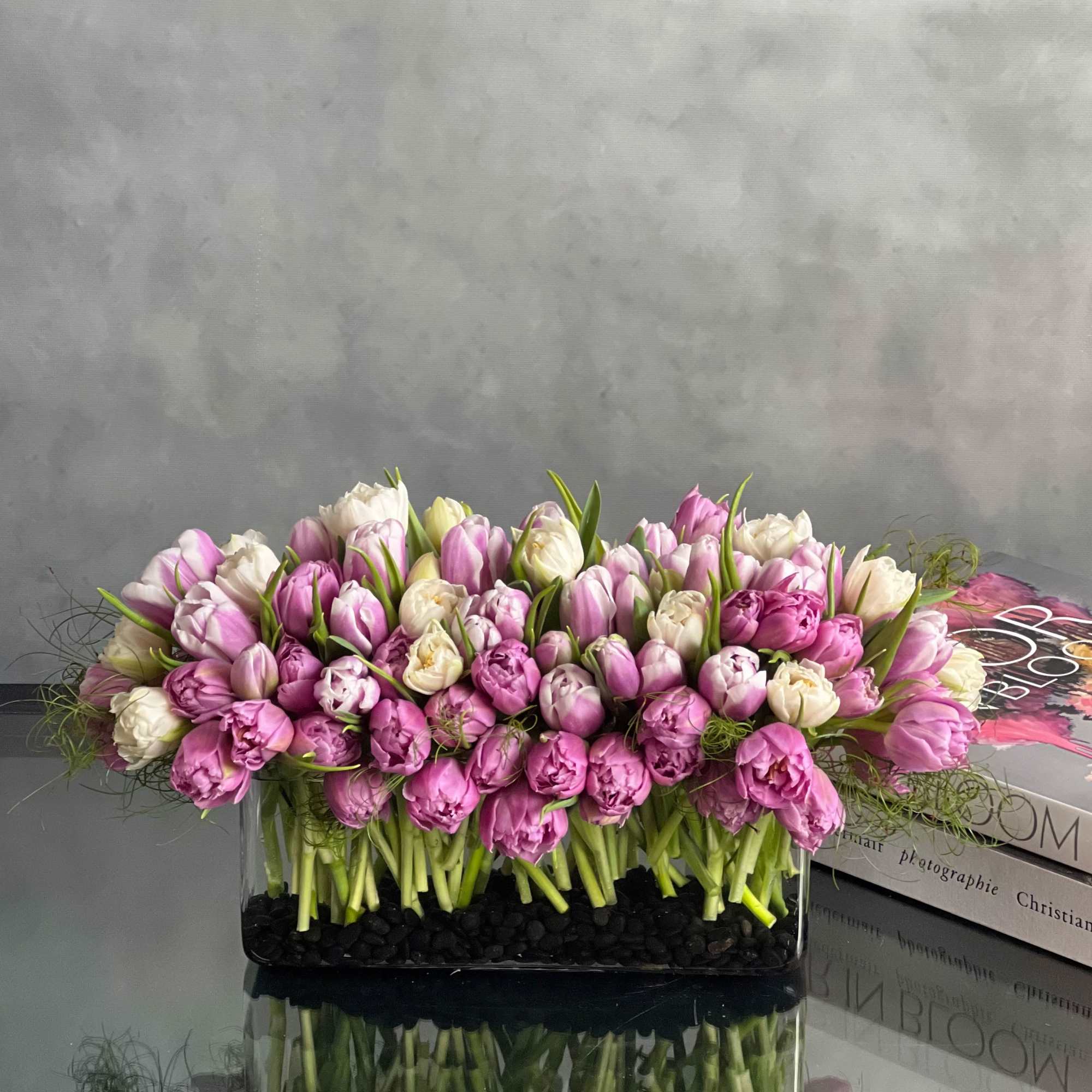 This modern low centerpiece of tulips will surely impressed anyone. Rows of