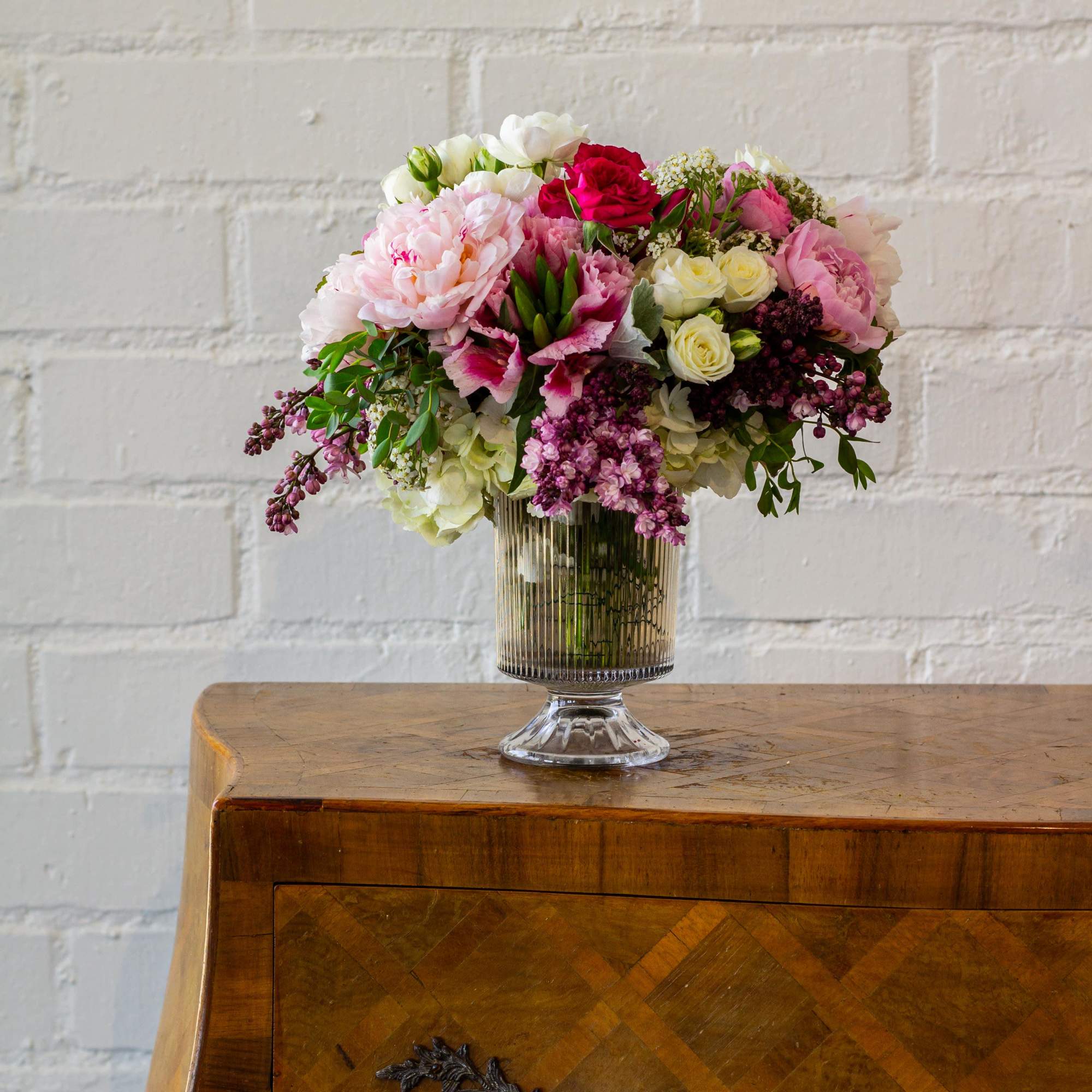For this exquisite floral arrangement, envision a captivating blend of peonies, lilacs, photo 2 of 5