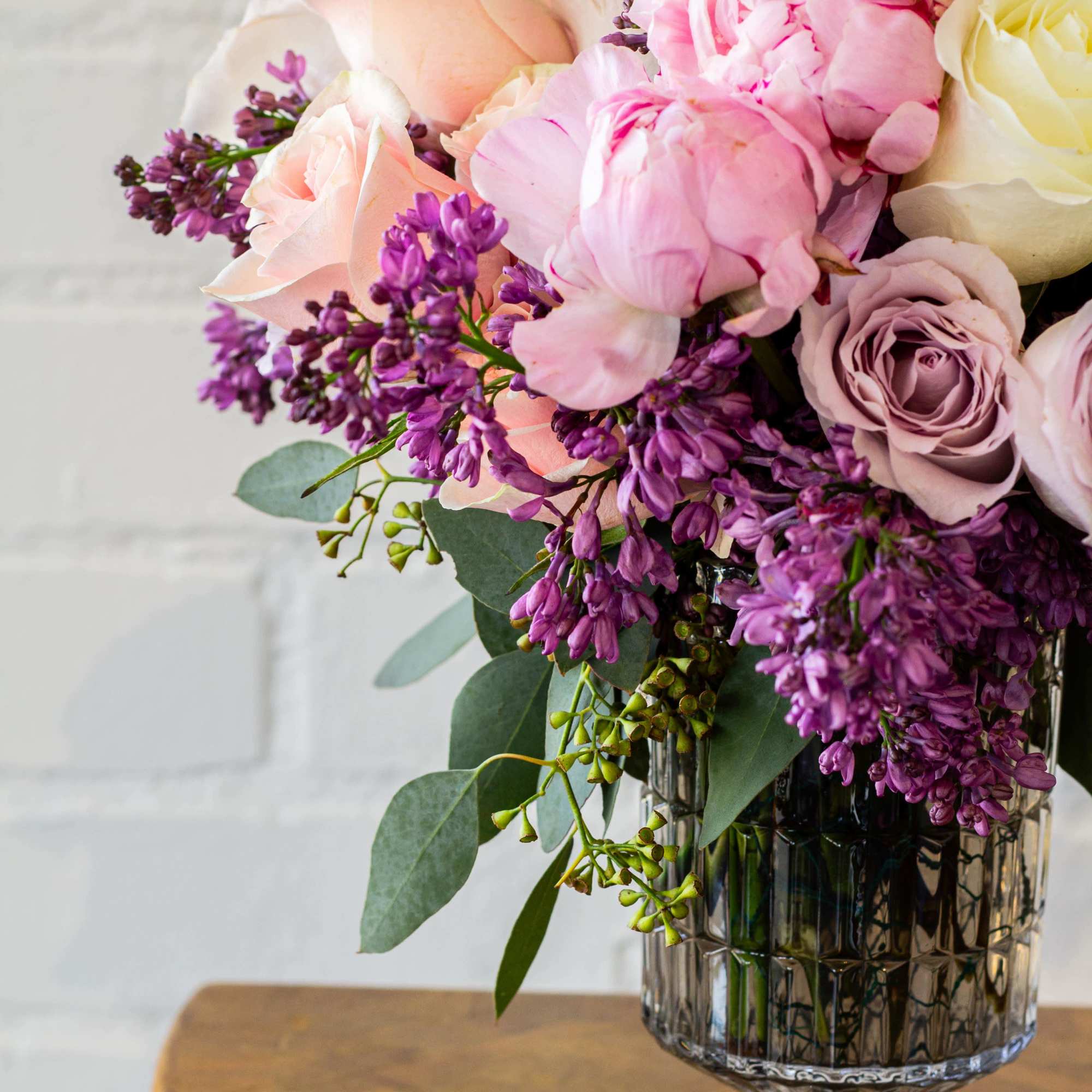 The luxurious floral arrangement features peonies, spray roses, and lilac artfully arranged, photo 3 of 5