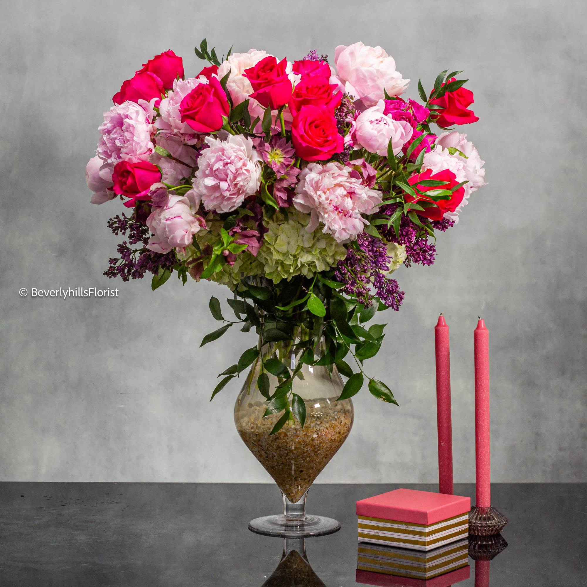 Elevate your surroundings with this opulent floral arrangement that marries the finest