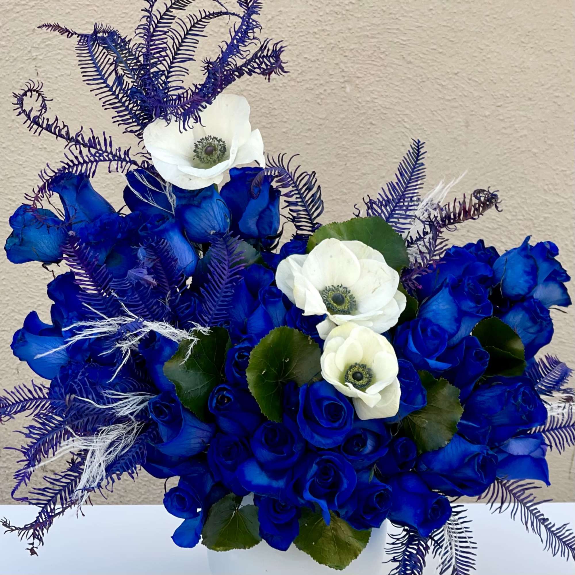 This modern blue arrangement featuring over 50 blooms of blue roses and, photo 2 of 2