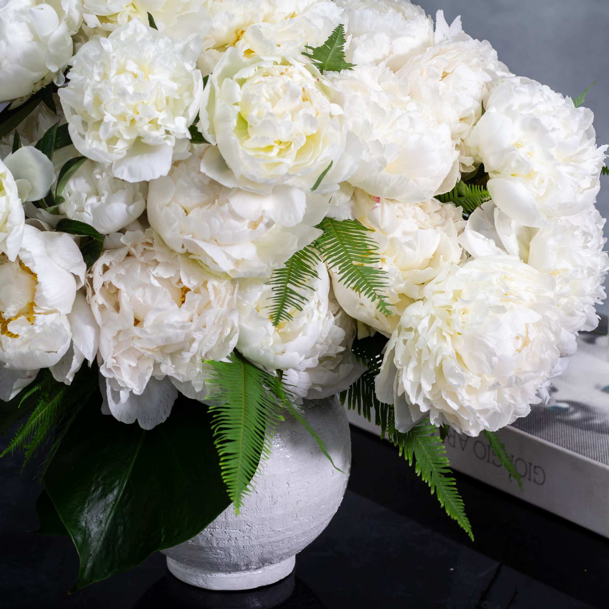  A lavish arrangement of over 20 pristine white peonies nestled within, photo 3 of 10