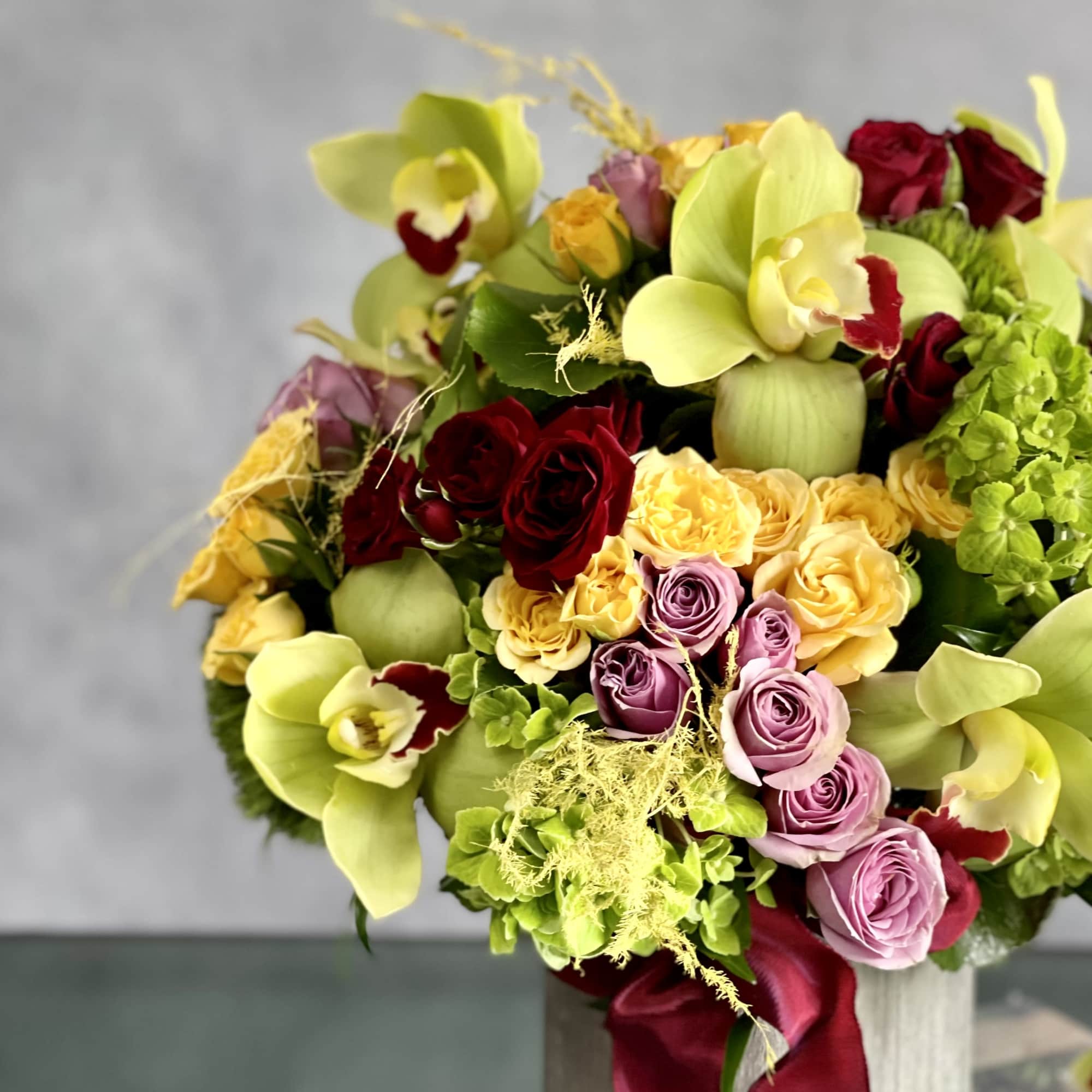 An amazing rounded bouquet of 12 vibrant green cymbidium , red, yellow, photo 2 of 4