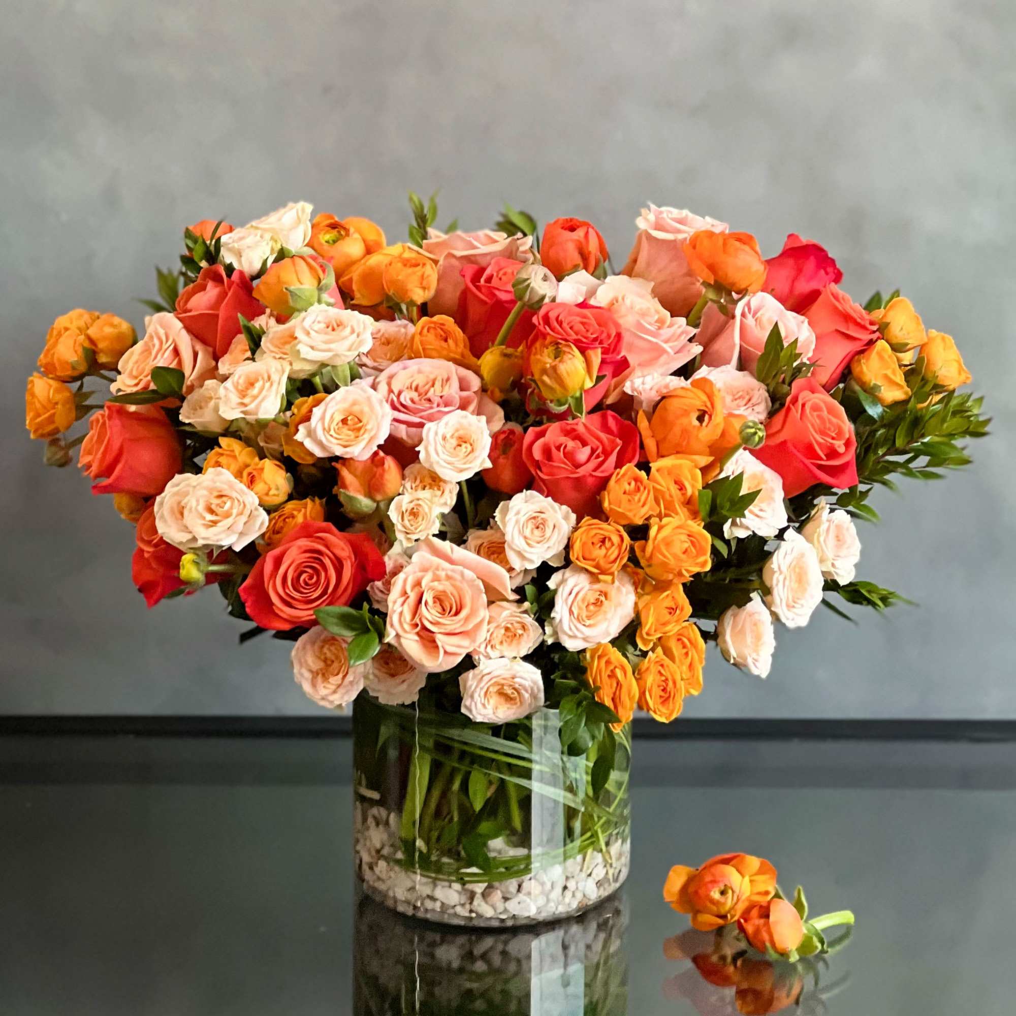 This upscale and uptown floral arrangement showcases a stunning combination of orange, photo 2 of 3
