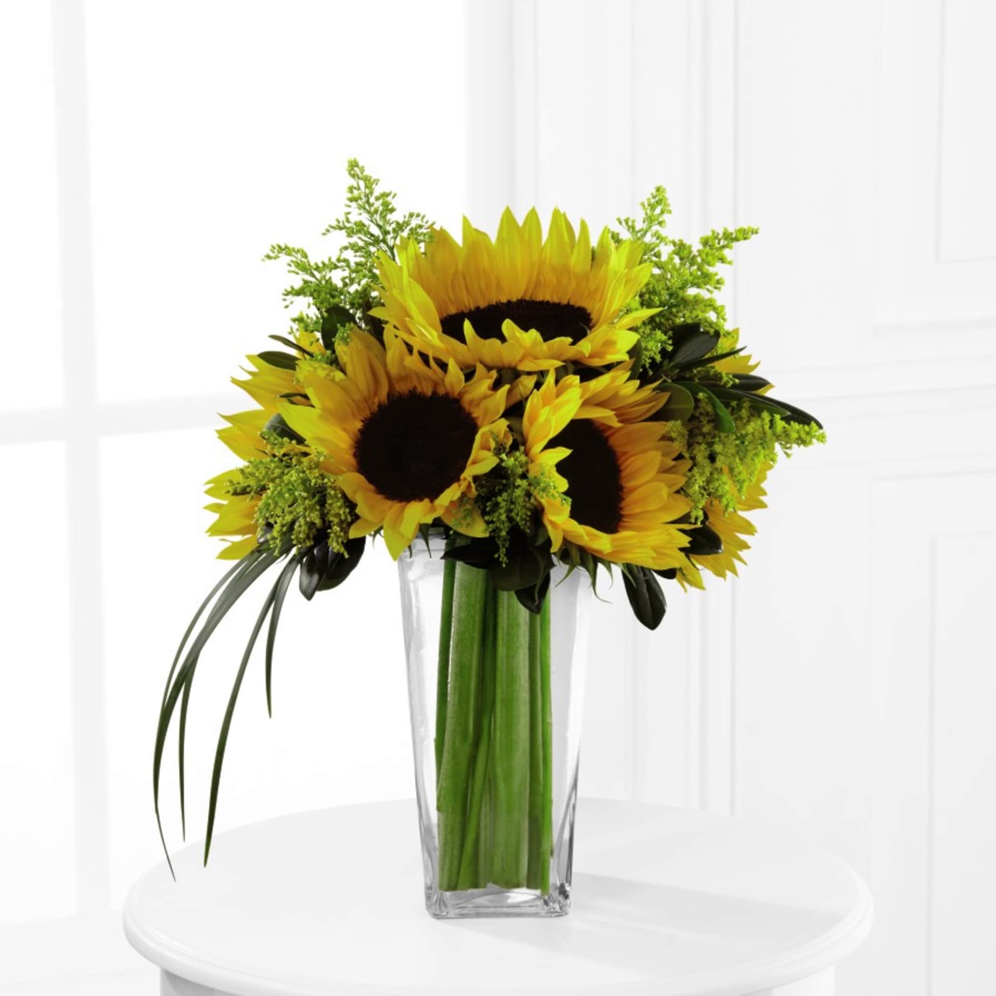 Sunflower bouquet in a clear glass vase, photo 2 of 2
