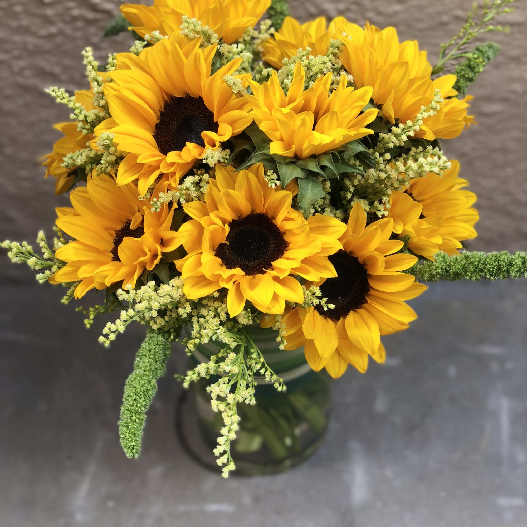Bouquet of yellow sunflowers in a glass vase