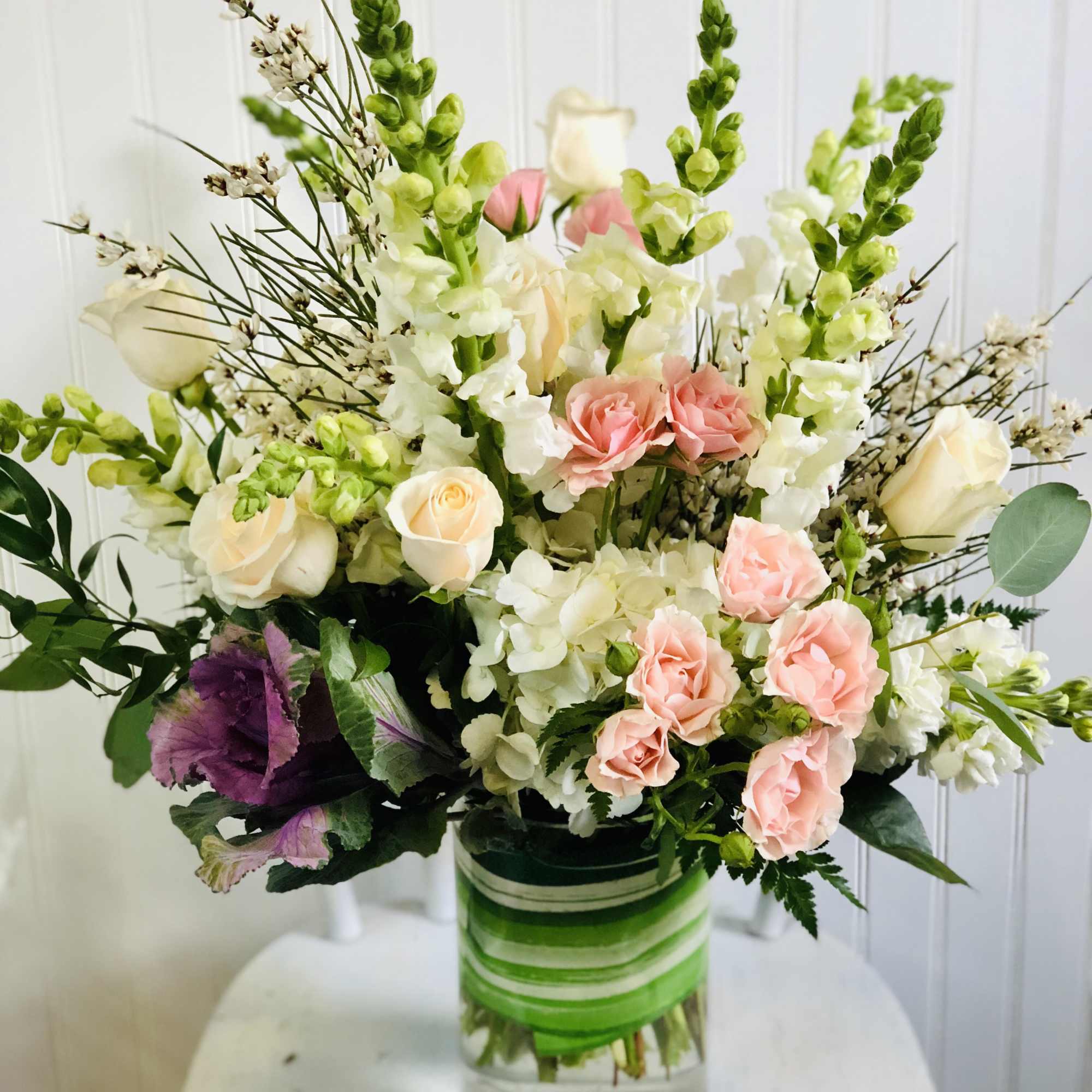 Mixed bouquet of pink and white flowers in a glass vase