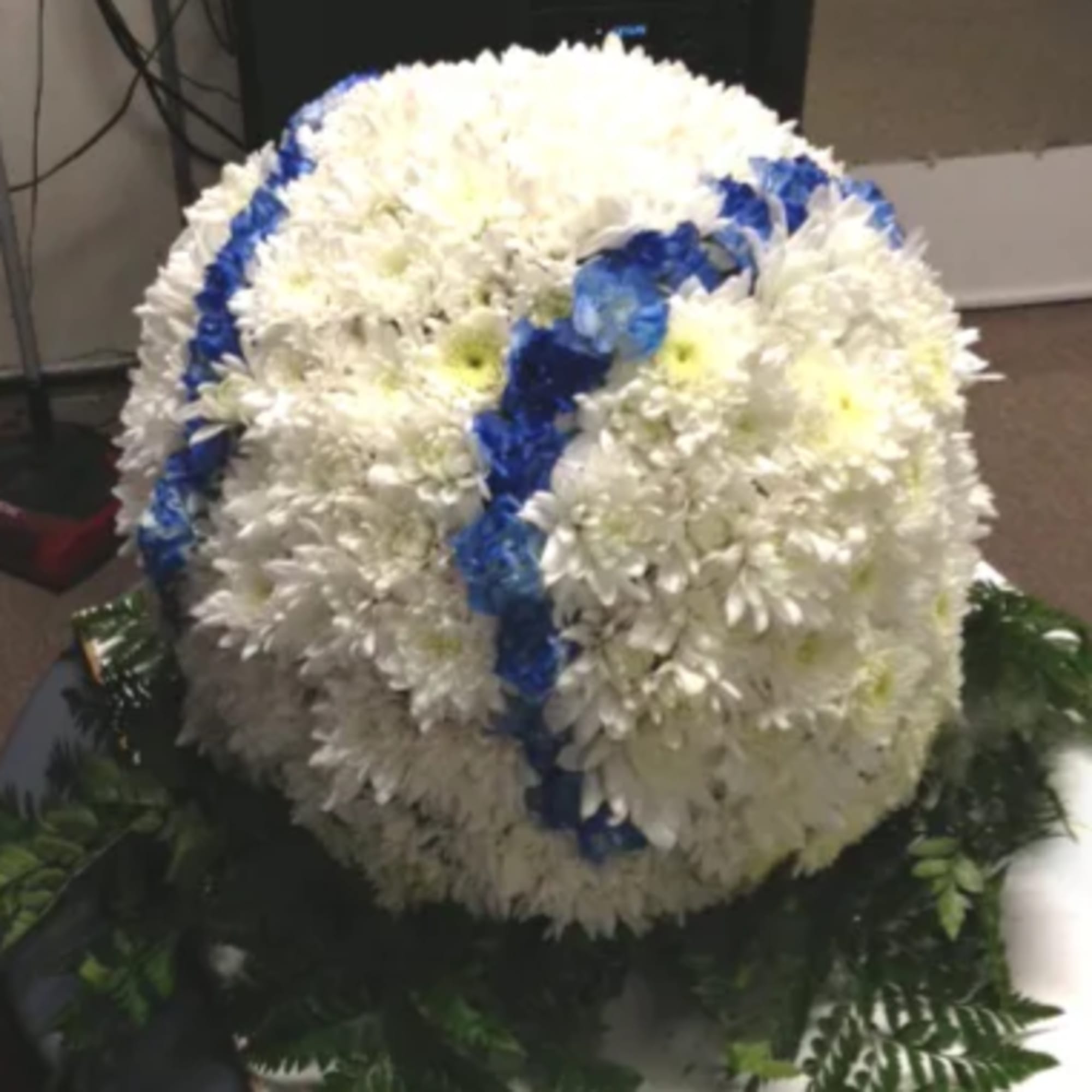White chrysanthemum funeral wreath with blue ribbon accents