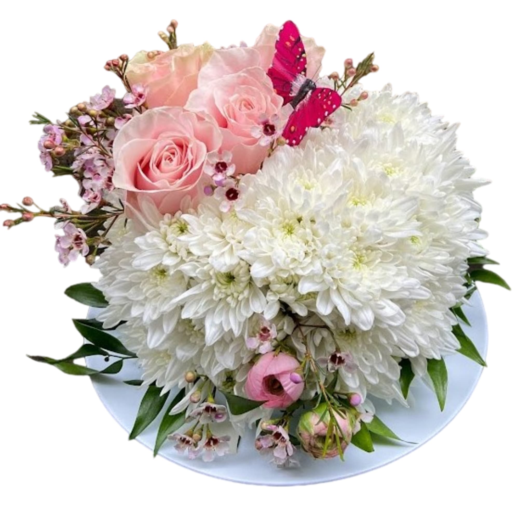 Low round arrangement of white chrysanthemums and pink roses with small pink blooms on a white dish and a pink butterfly.