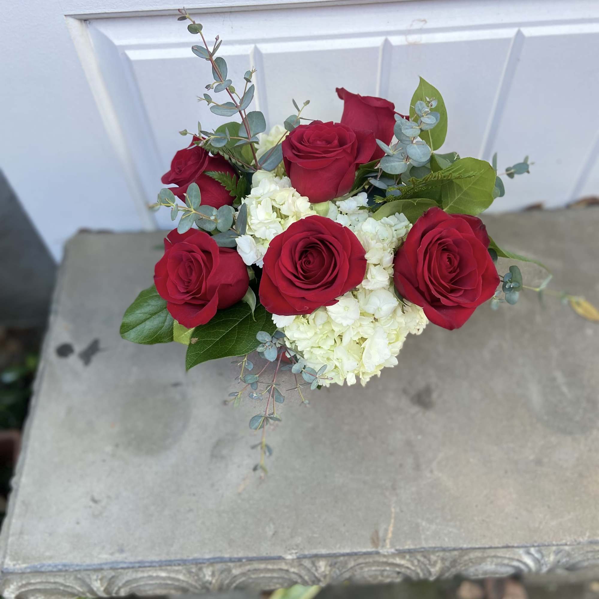 Bouquet of red roses and white hydrangeas with eucalyptus