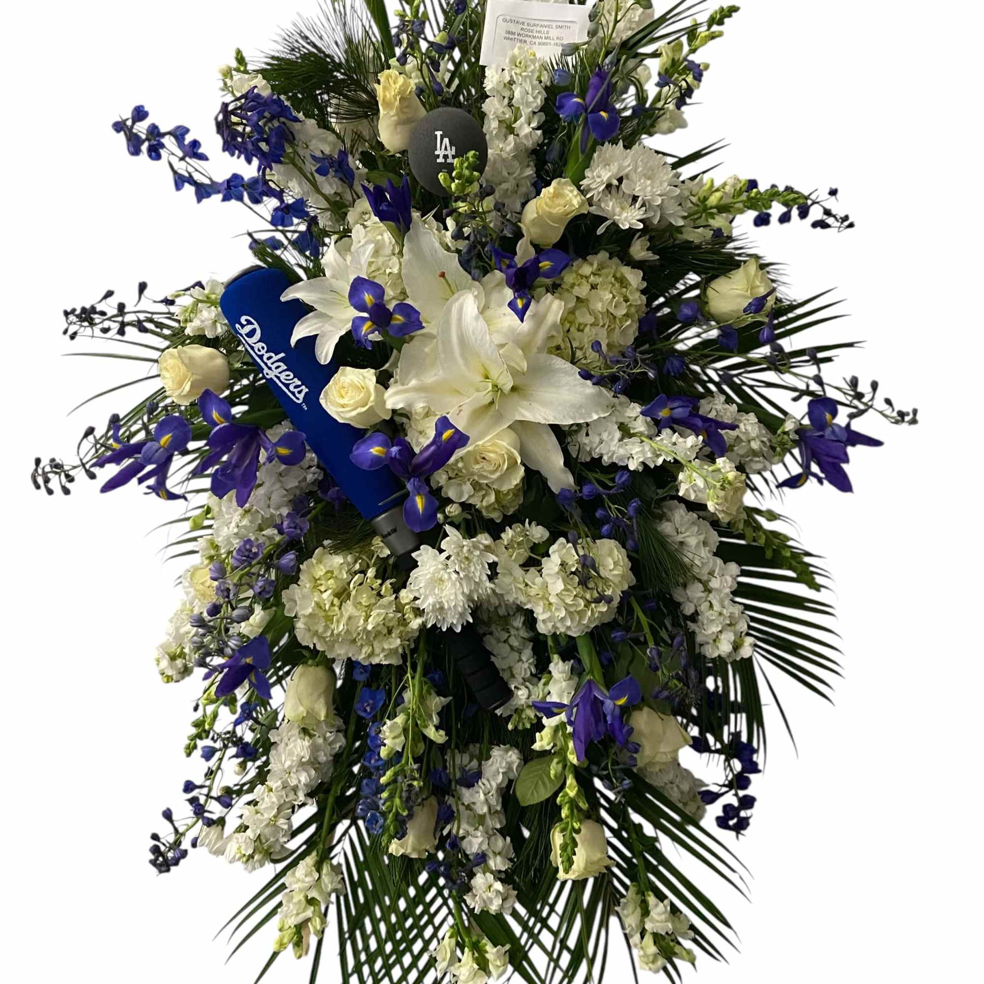 Large white and blue funeral spray with lilies and roses