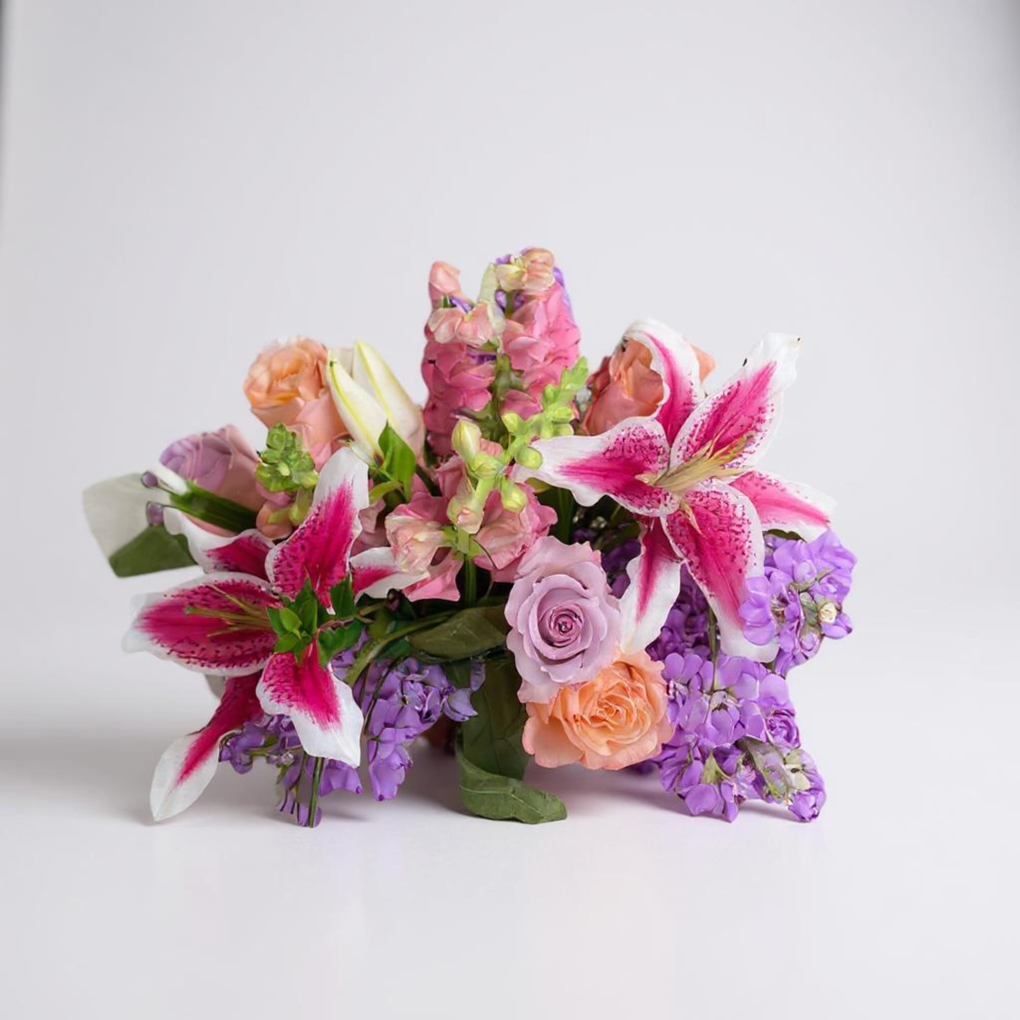 Bouquet of pink lilies, roses, and purple flowers