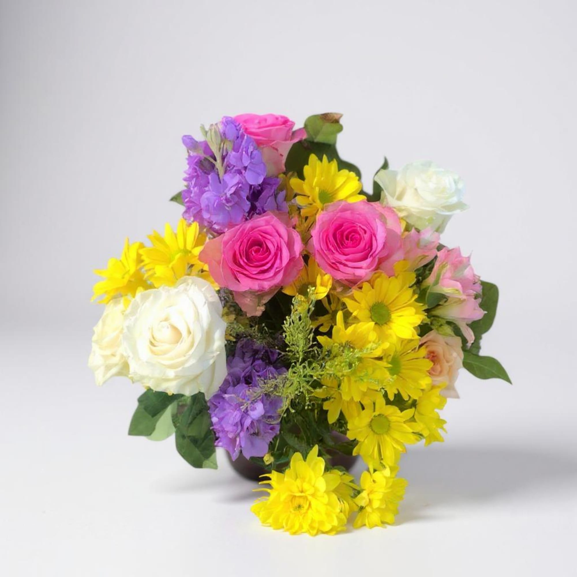 Bouquet of pink and white roses with yellow and purple daisies in a vase