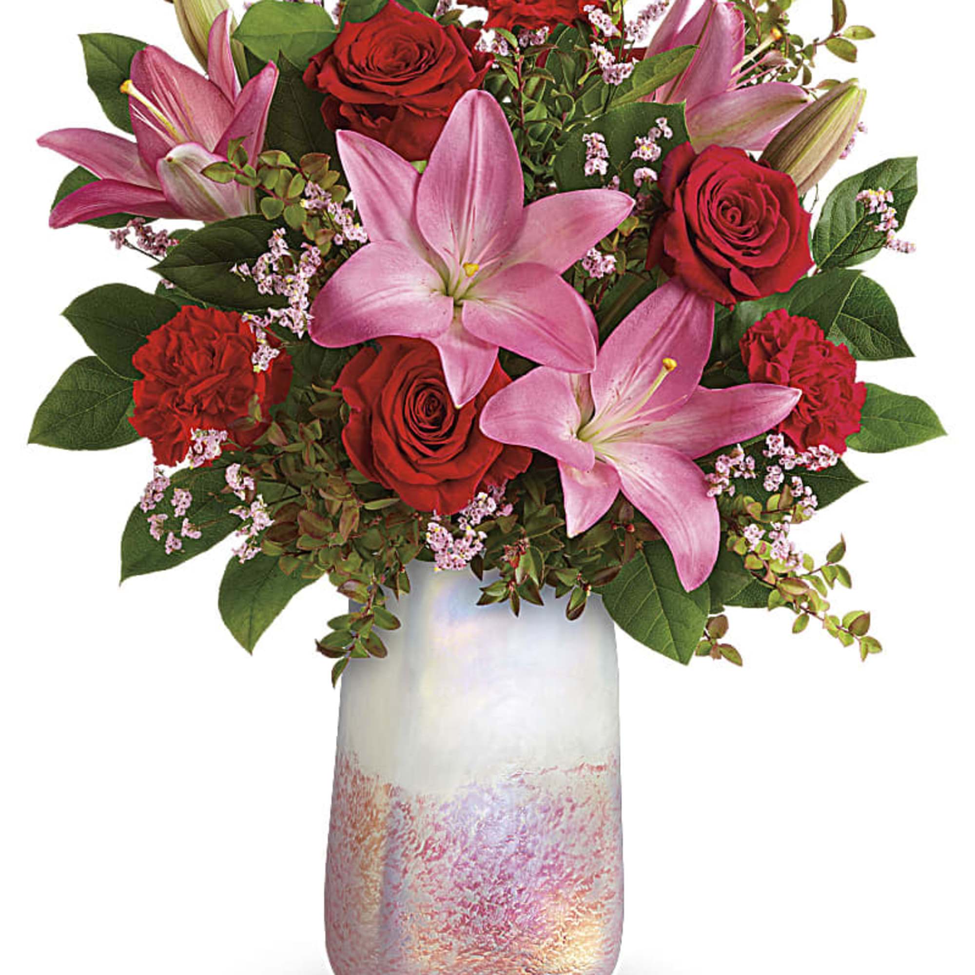 Pink lilies and red roses in a frosted glass vase