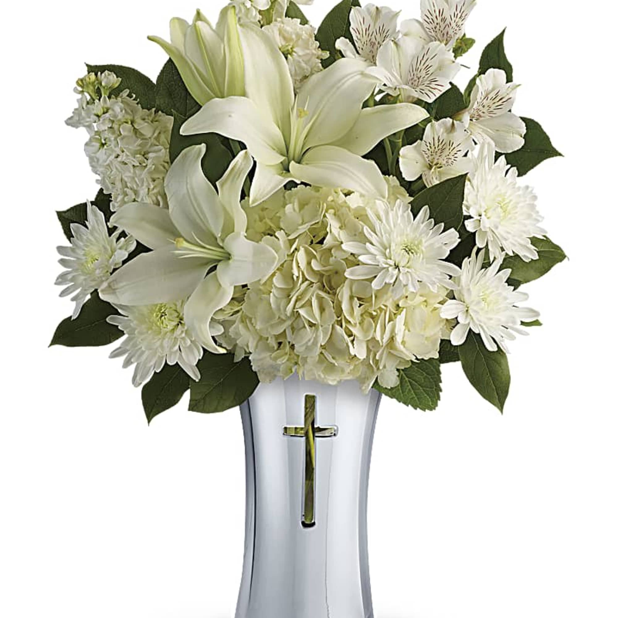 White lilies and daisies arranged in a silver vase with a cross cutout