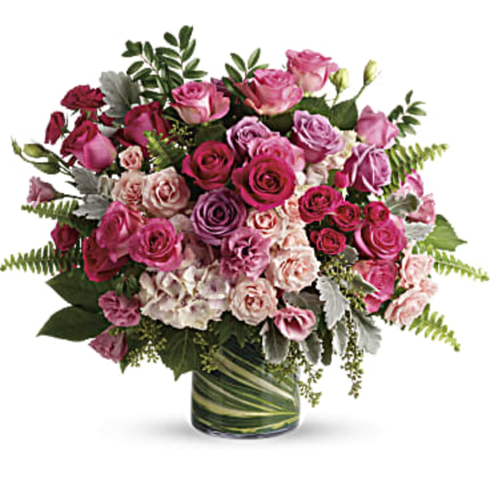 Bouquet of pink and lavender roses in a glass vase
