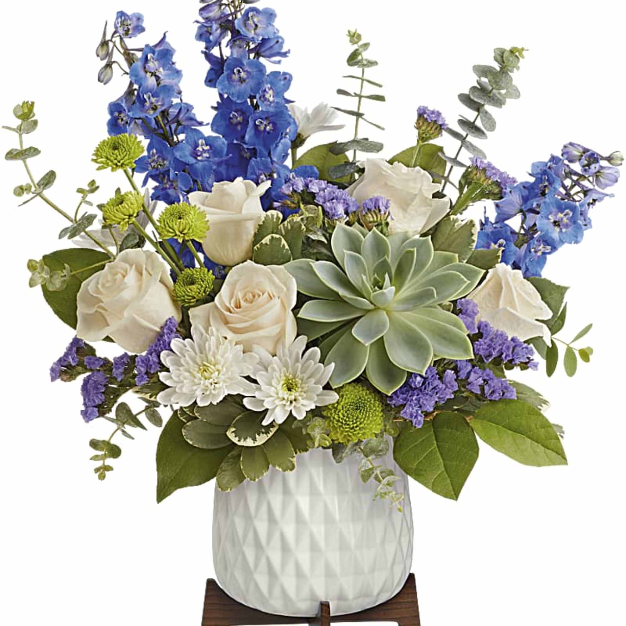 Blue and white floral arrangement in a white vase with a succulent
