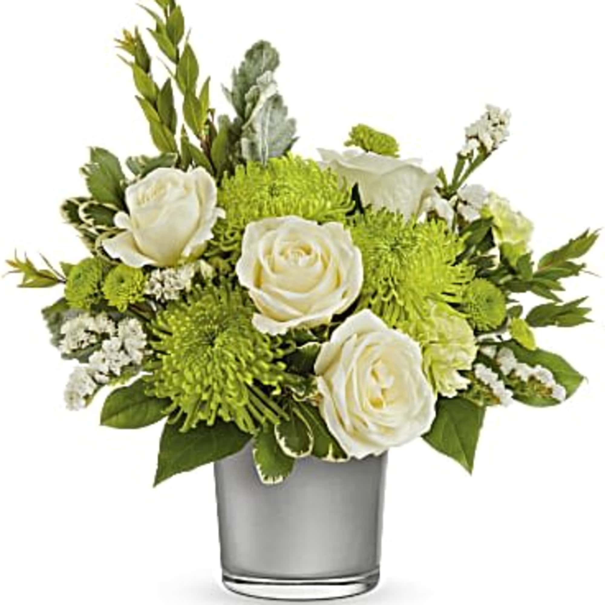 White roses and green chrysanthemums in a clear glass vase