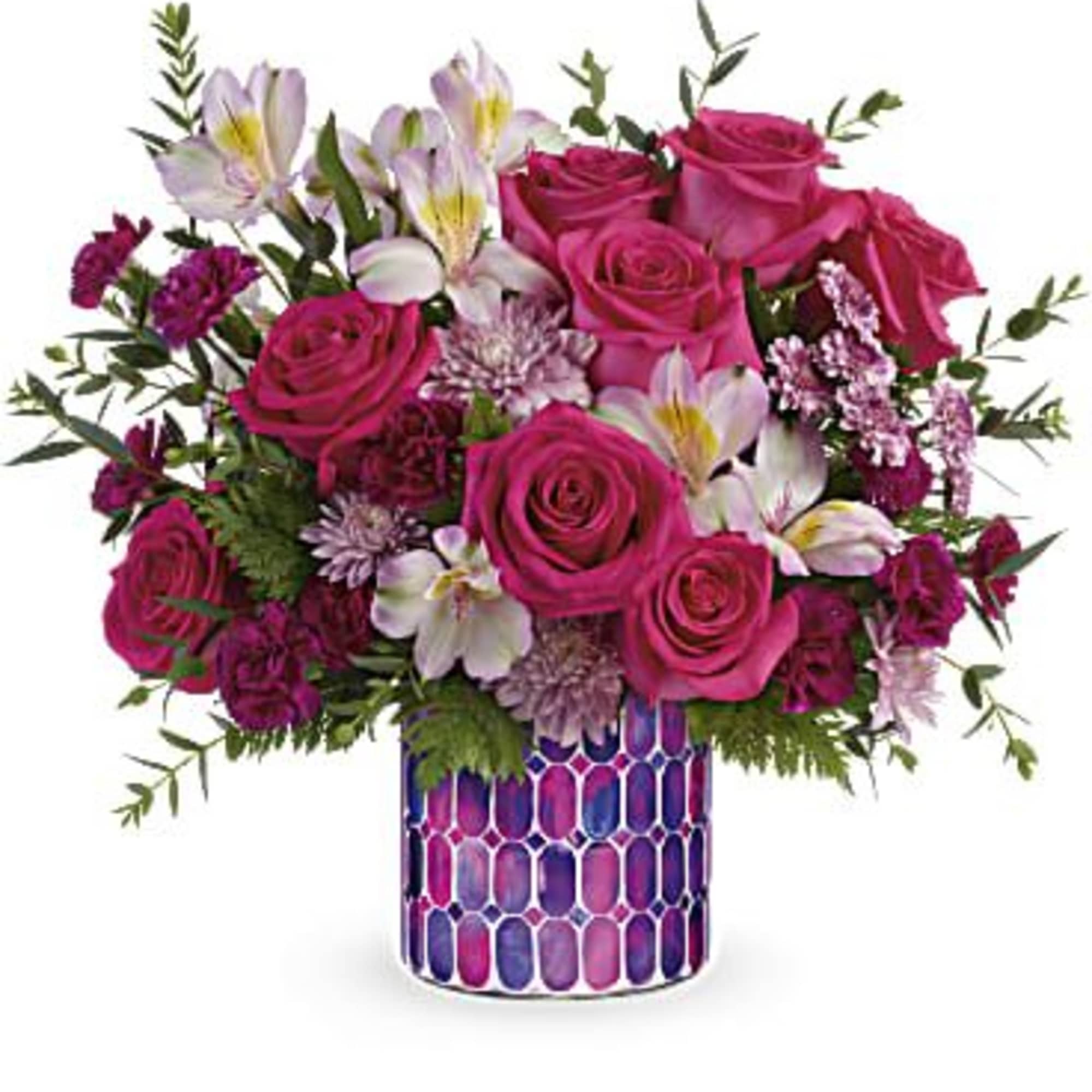 Pink roses and mixed blooms in a patterned vase
