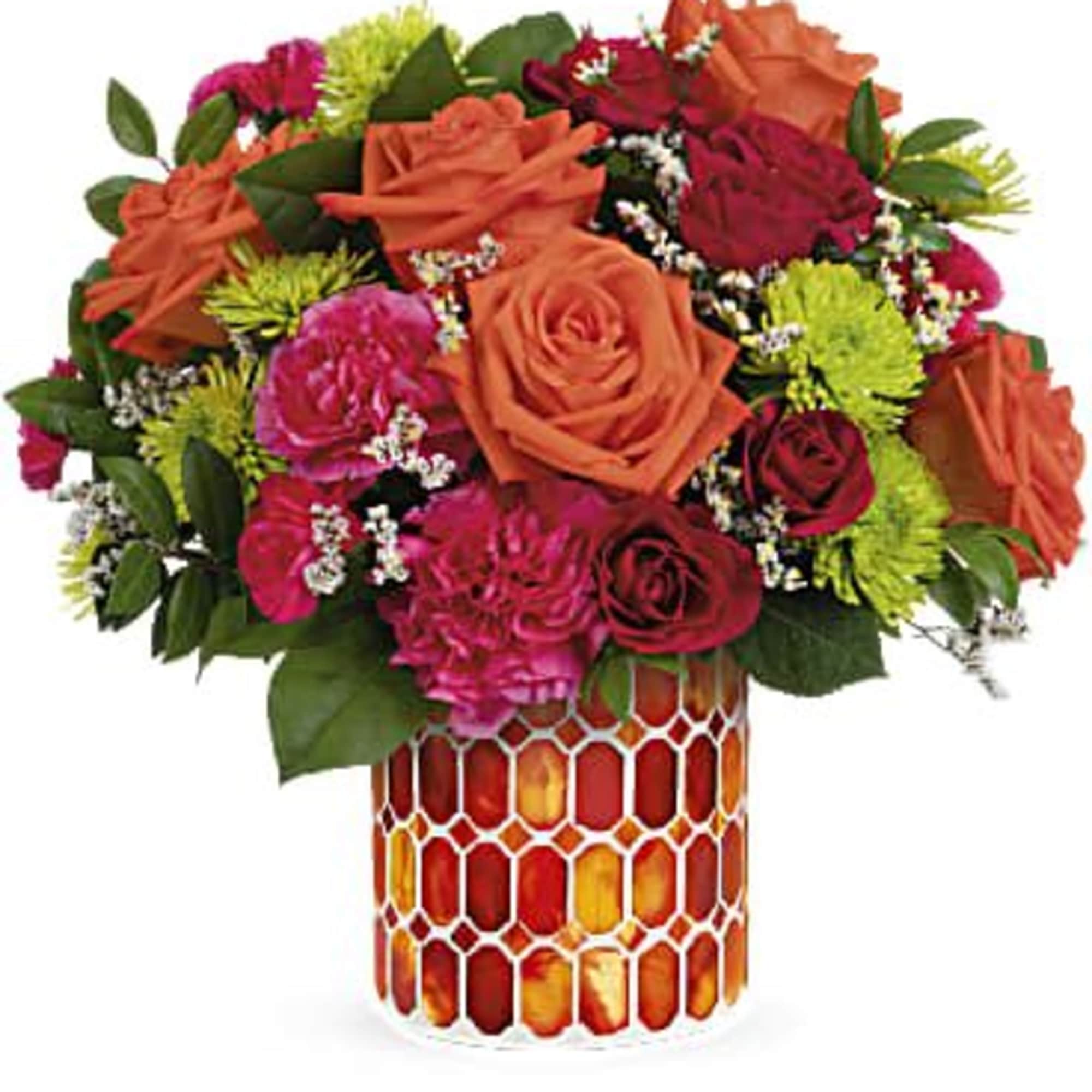 Bouquet of orange and pink roses in a patterned vase