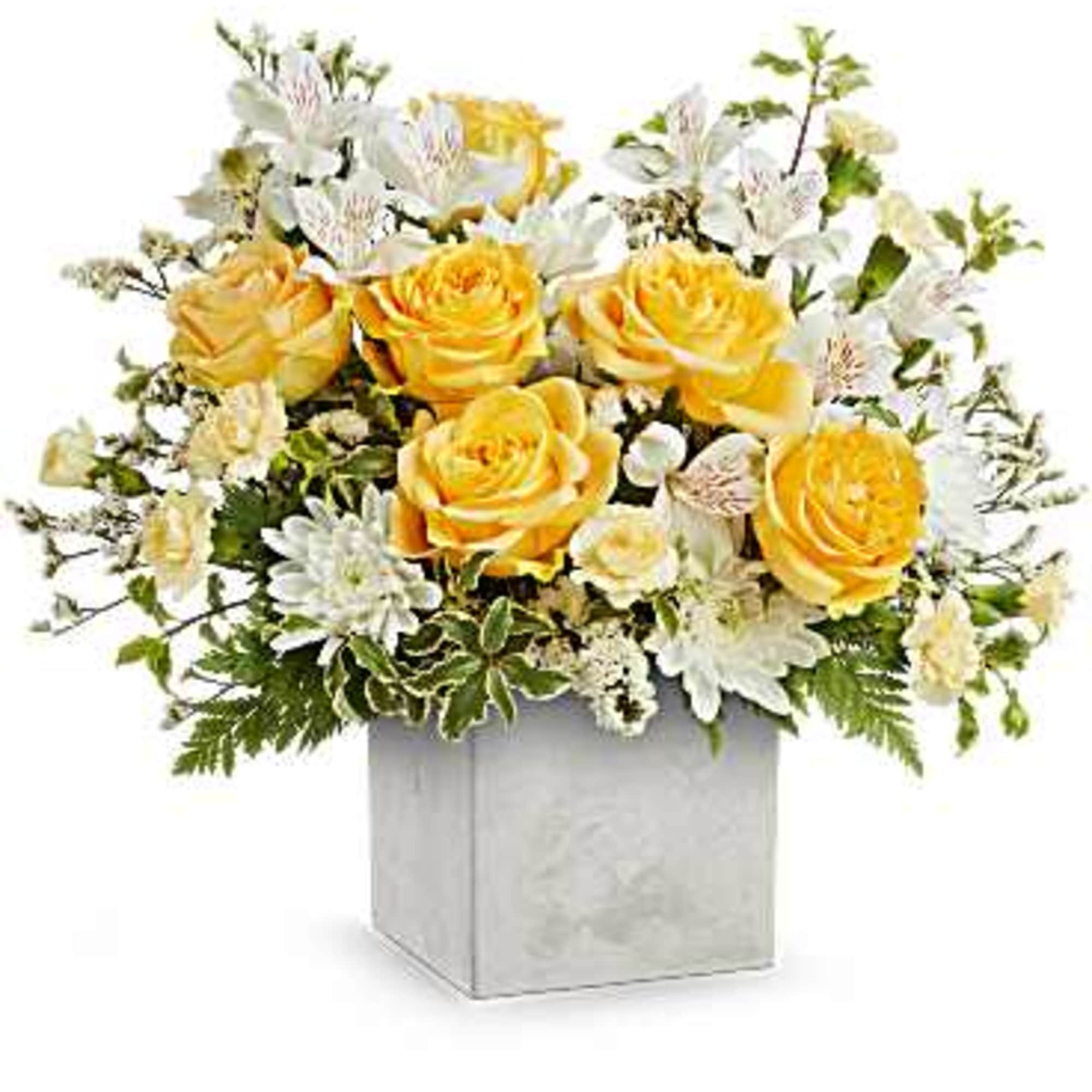 Yellow roses and white flowers arranged in a square vase