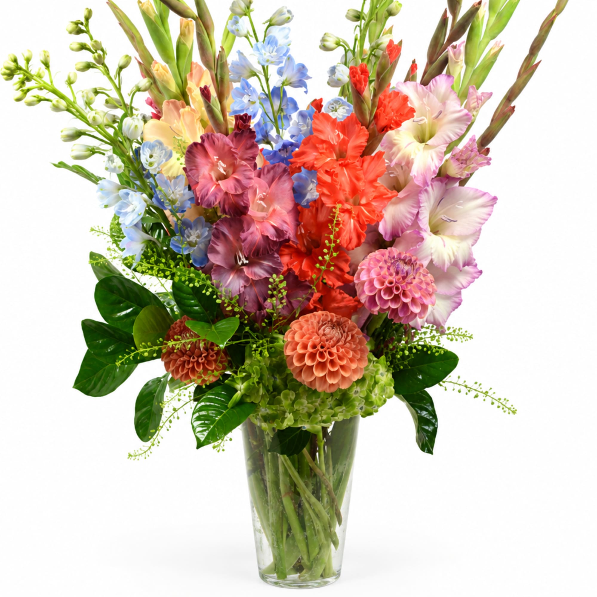 Colorful mixed bouquet in a clear glass vase with tall blooms
