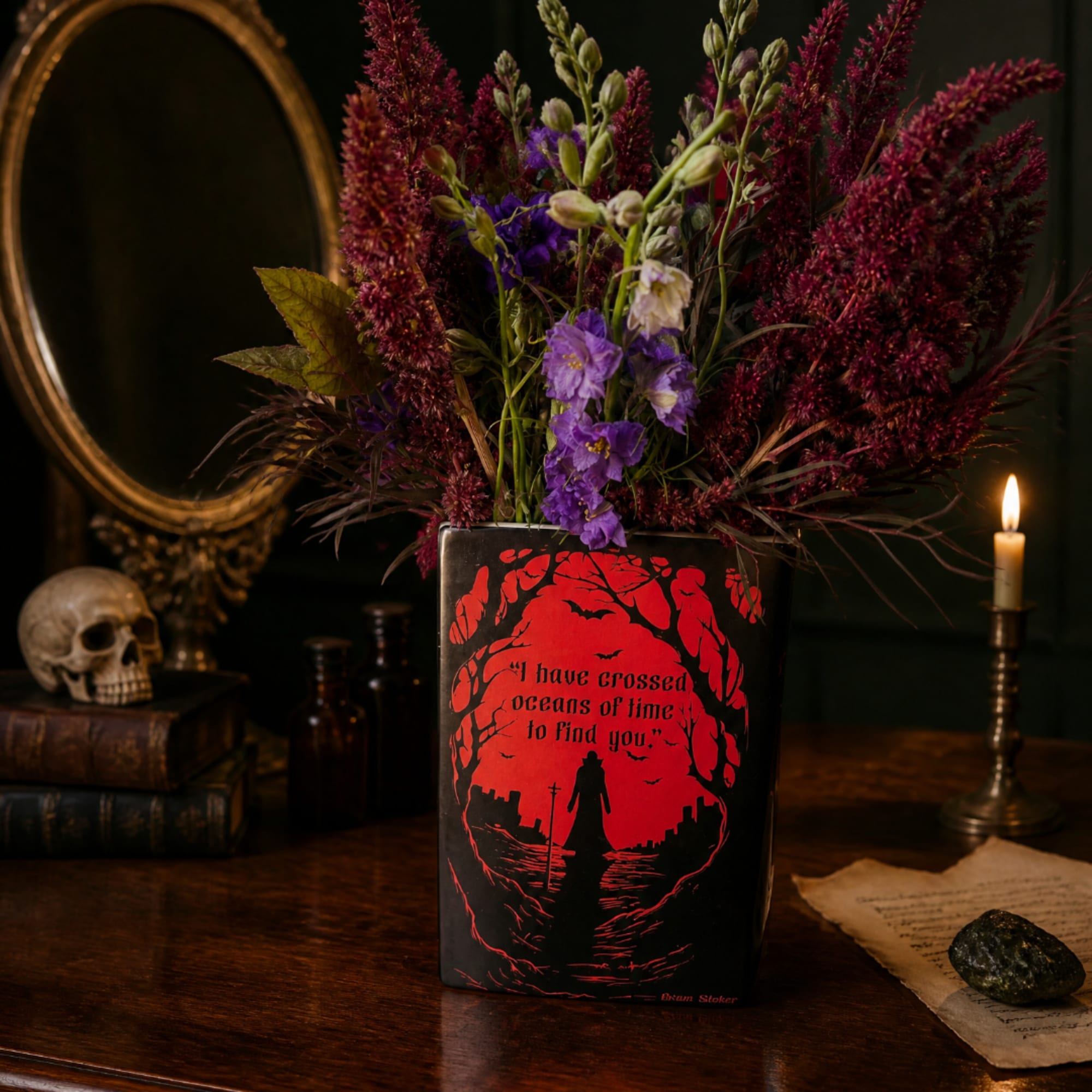 Purple flowers in a black vase with a red graphic design