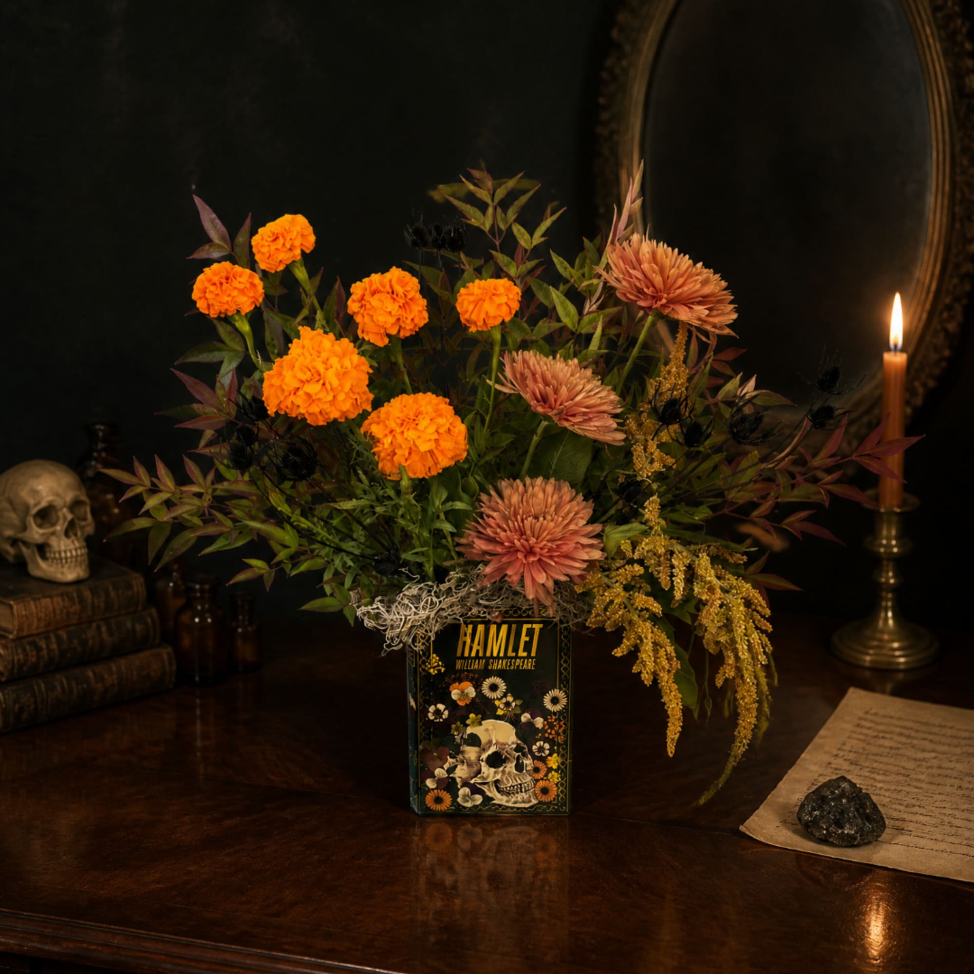 Orange and blush flowers arranged in a Hamlet book vase
