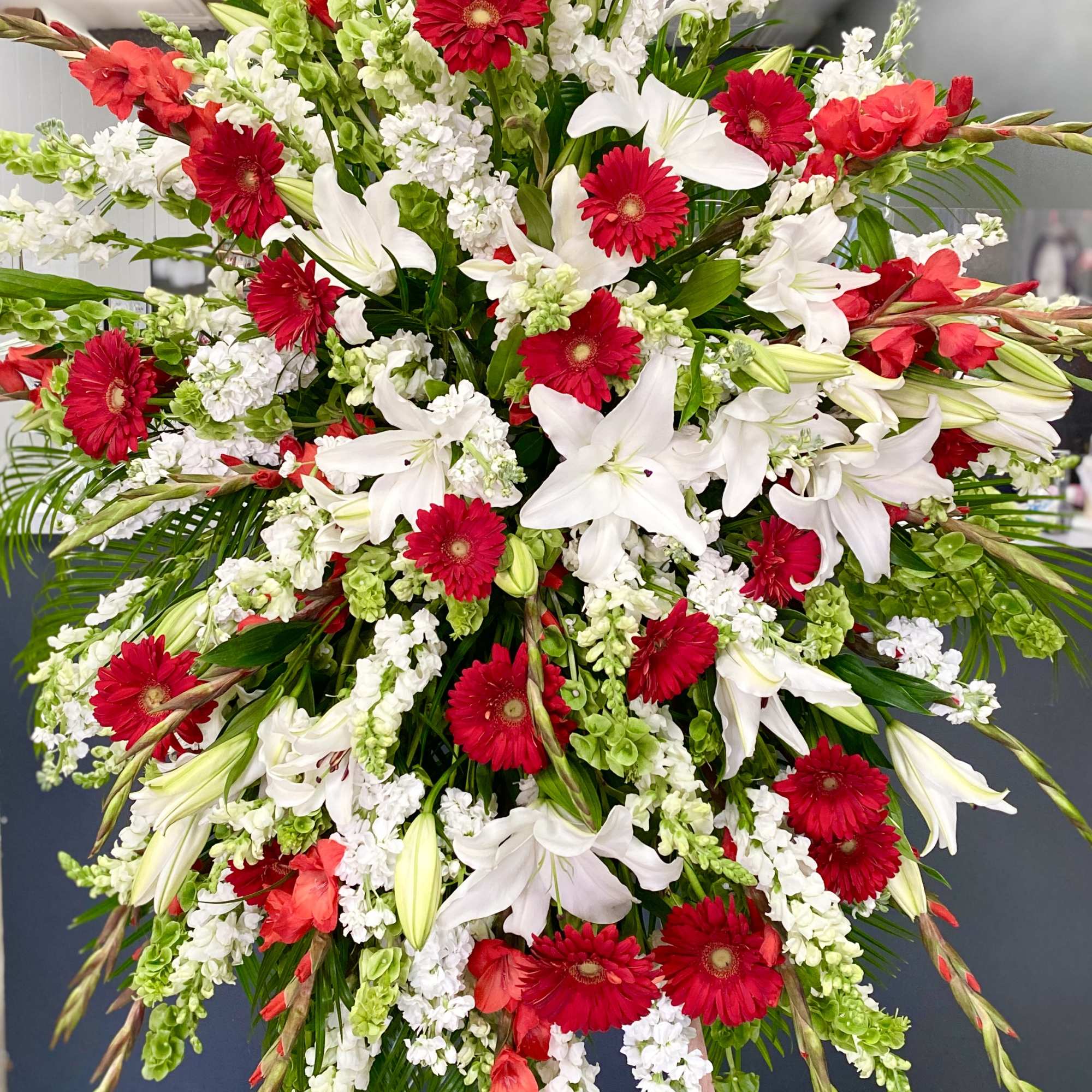Large red and white floral spray on an easel