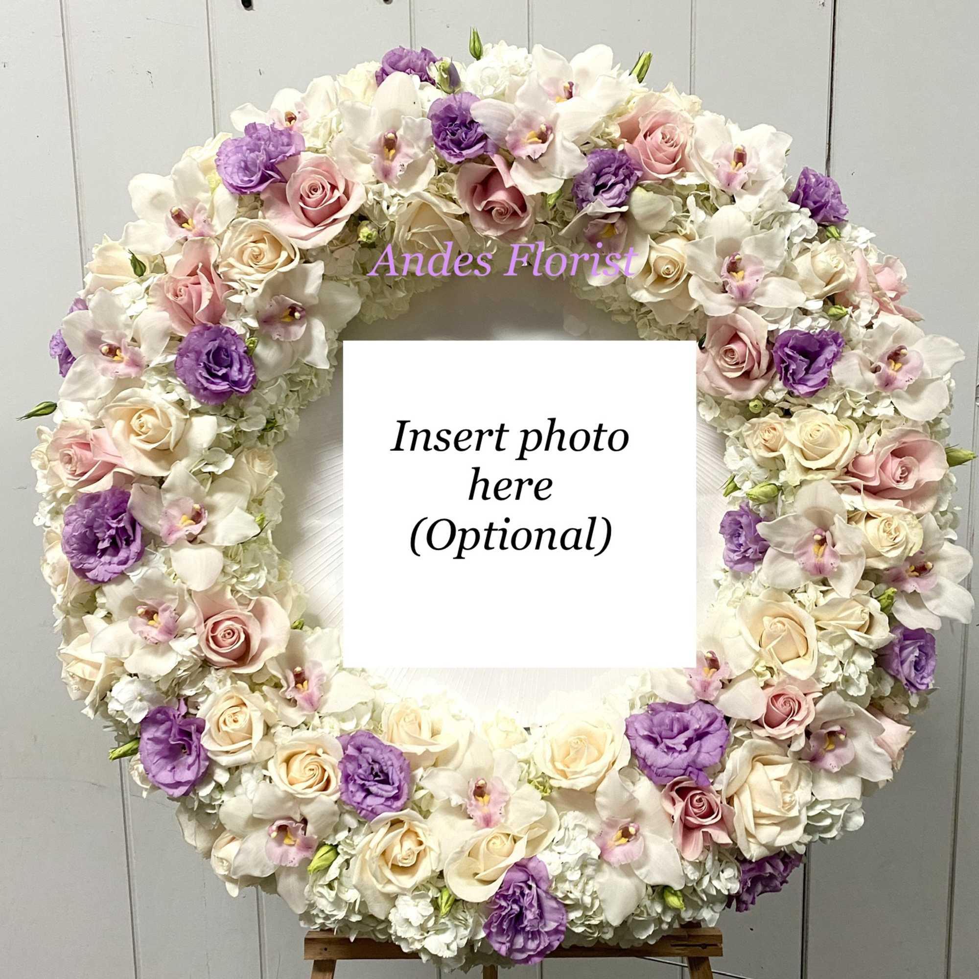 Large floral wreath with pink, white, and purple blooms around a photo opening