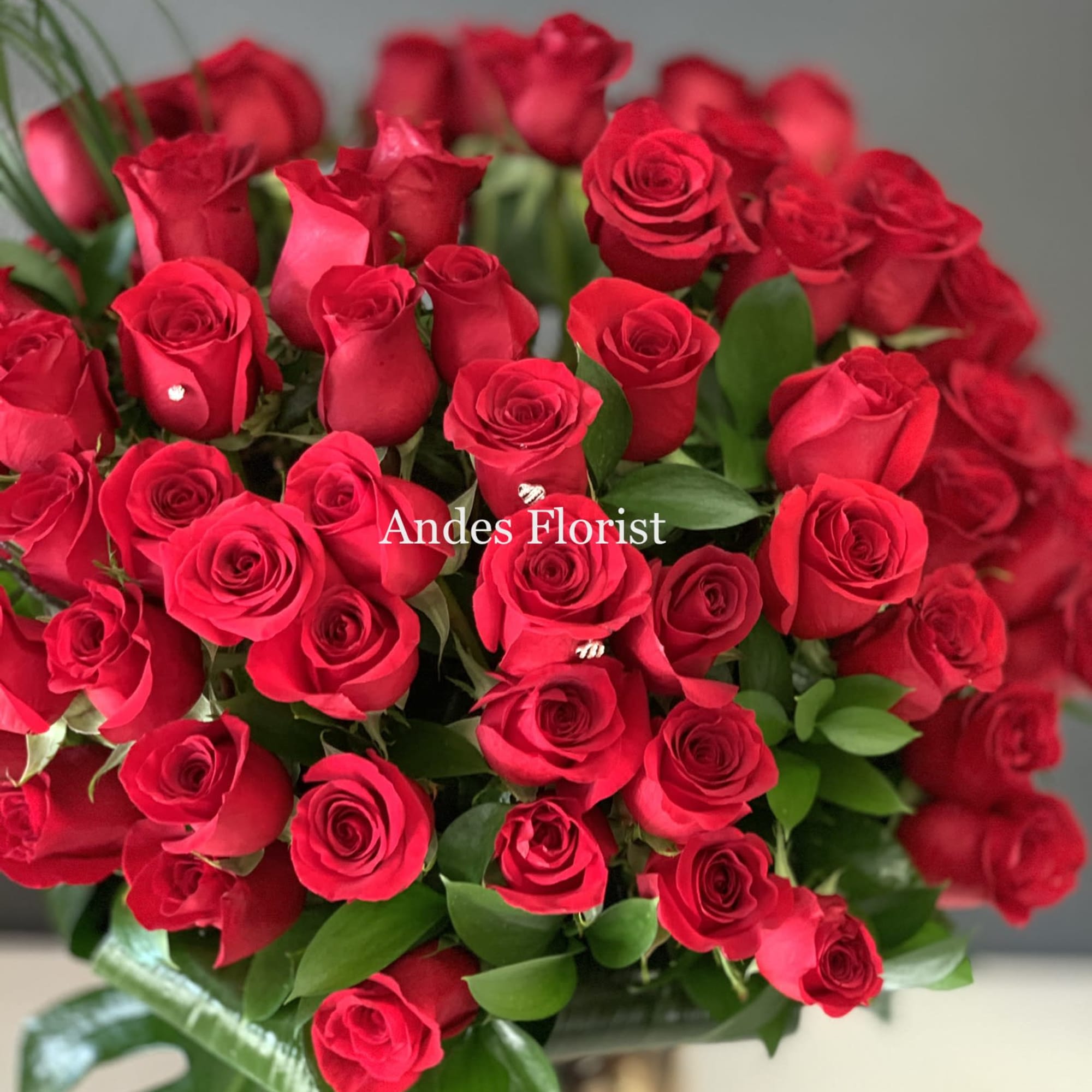 Bouquet of red roses with greenery
