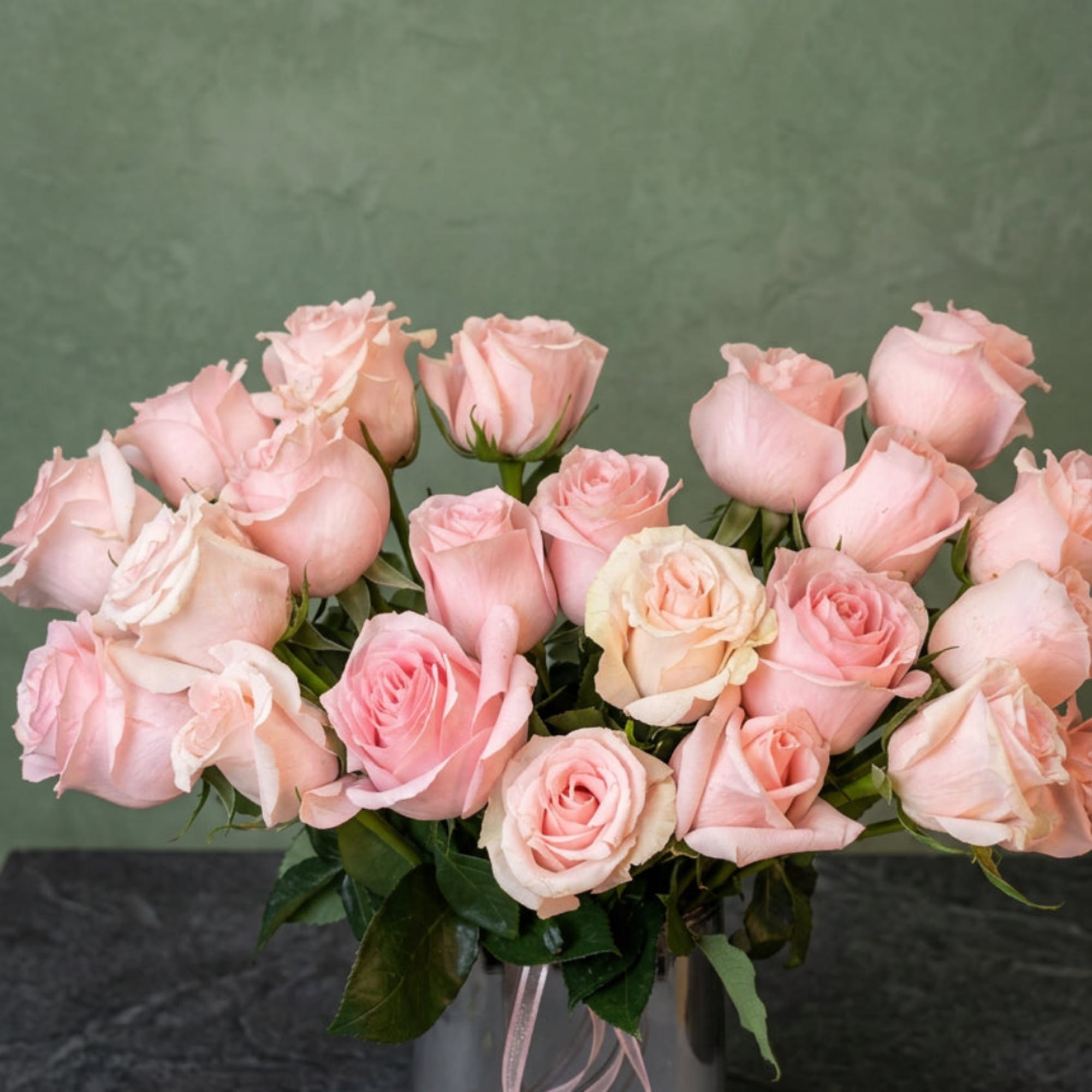 Bouquet of pale pink roses in a clear glass vase