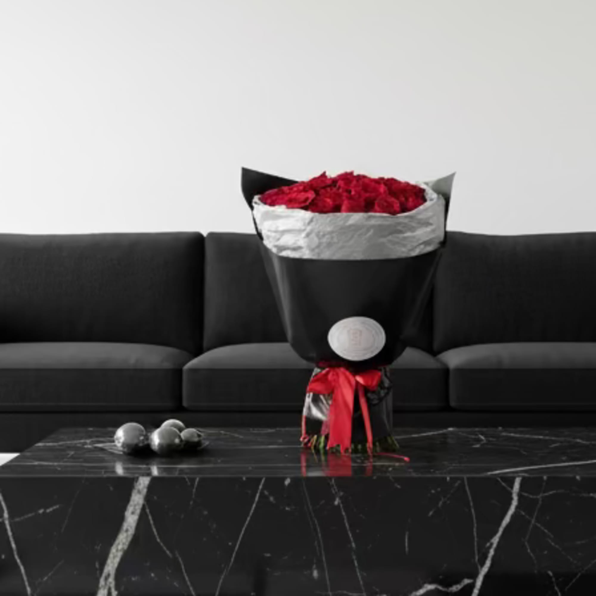 A striking hand-wrapped bouquet of premium red rose stems, finished in sleek
