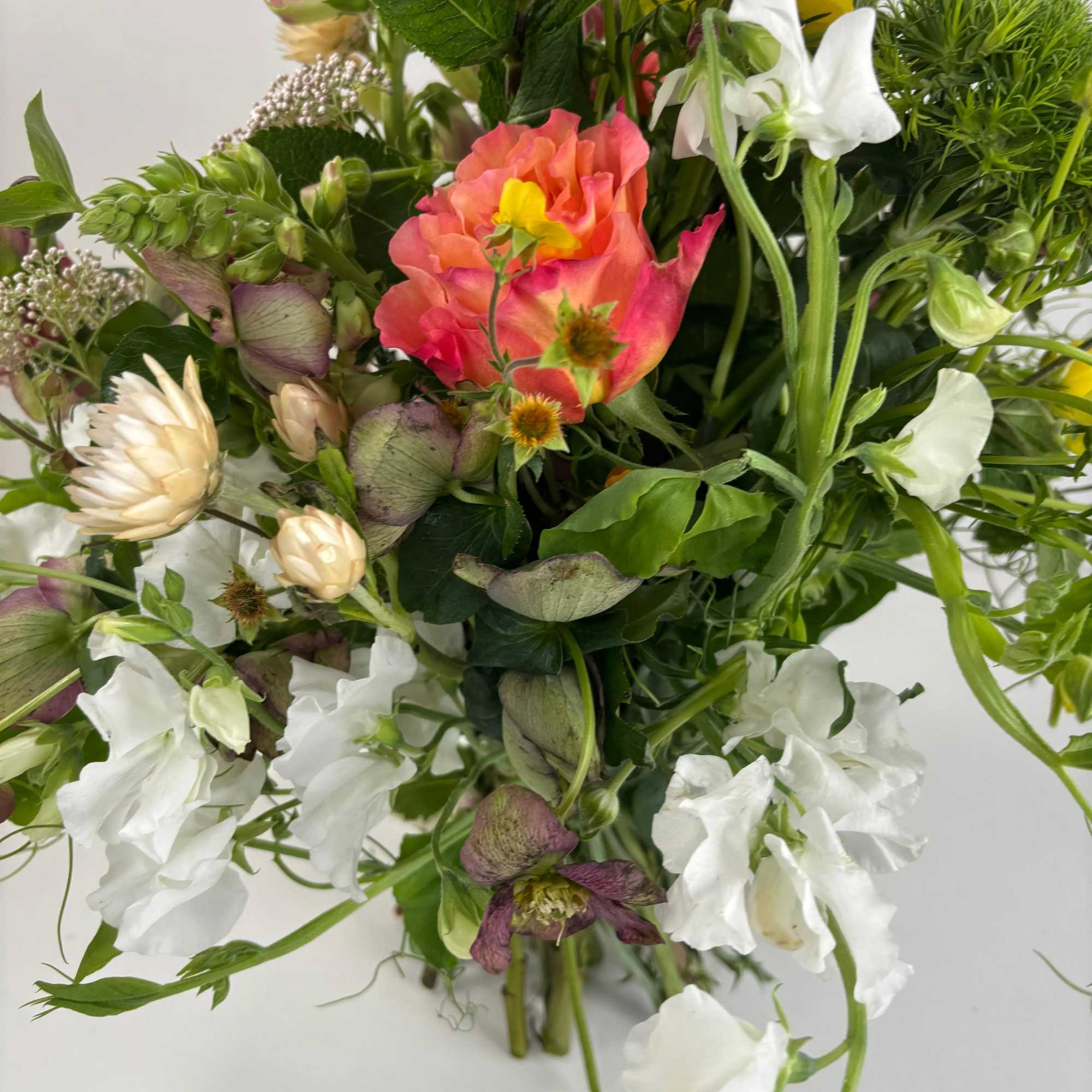 Mixed bouquet with white and pink flowers and green foliage